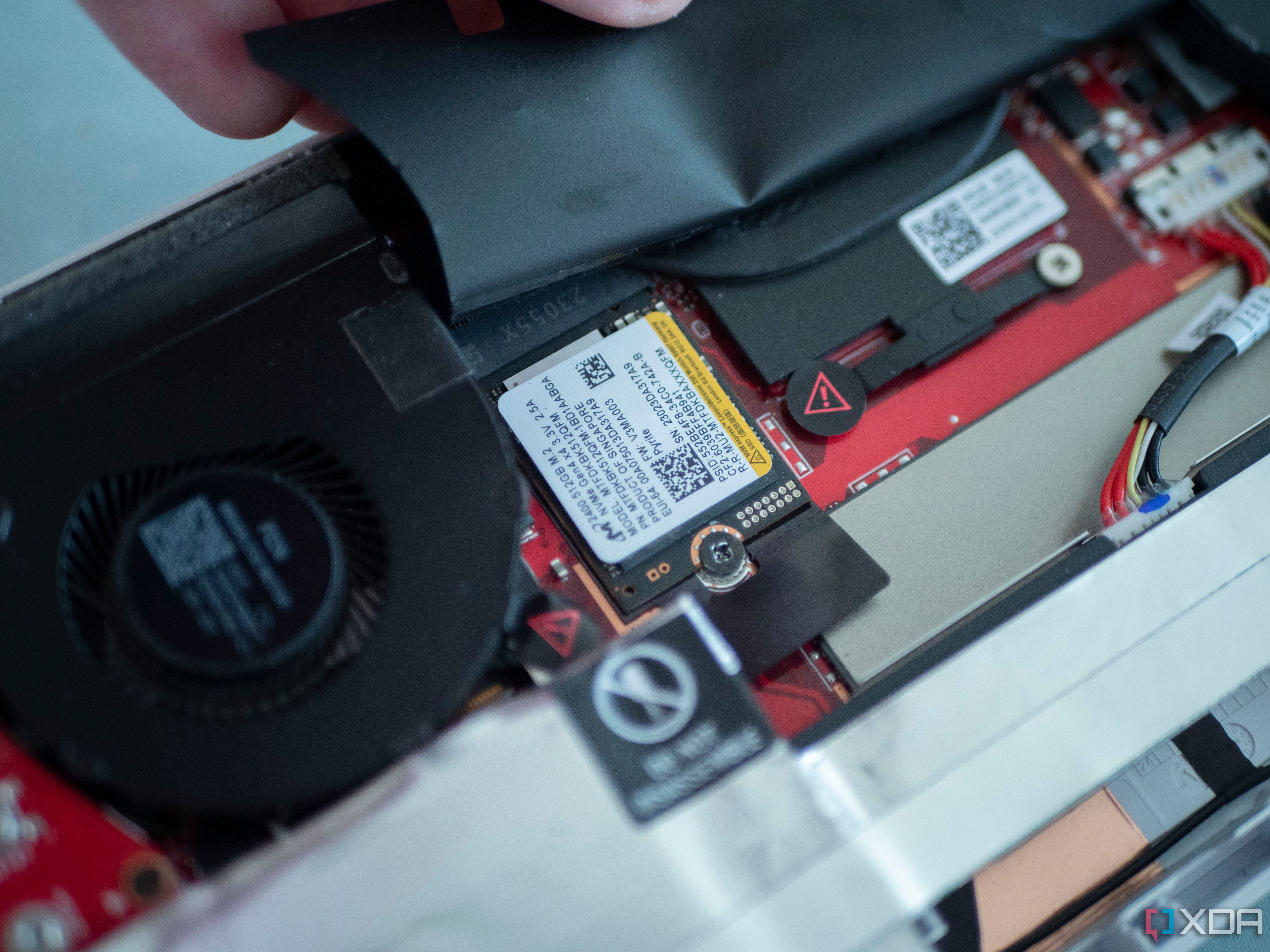 Inserting an SSD into the back of the Asus ROG Ally.