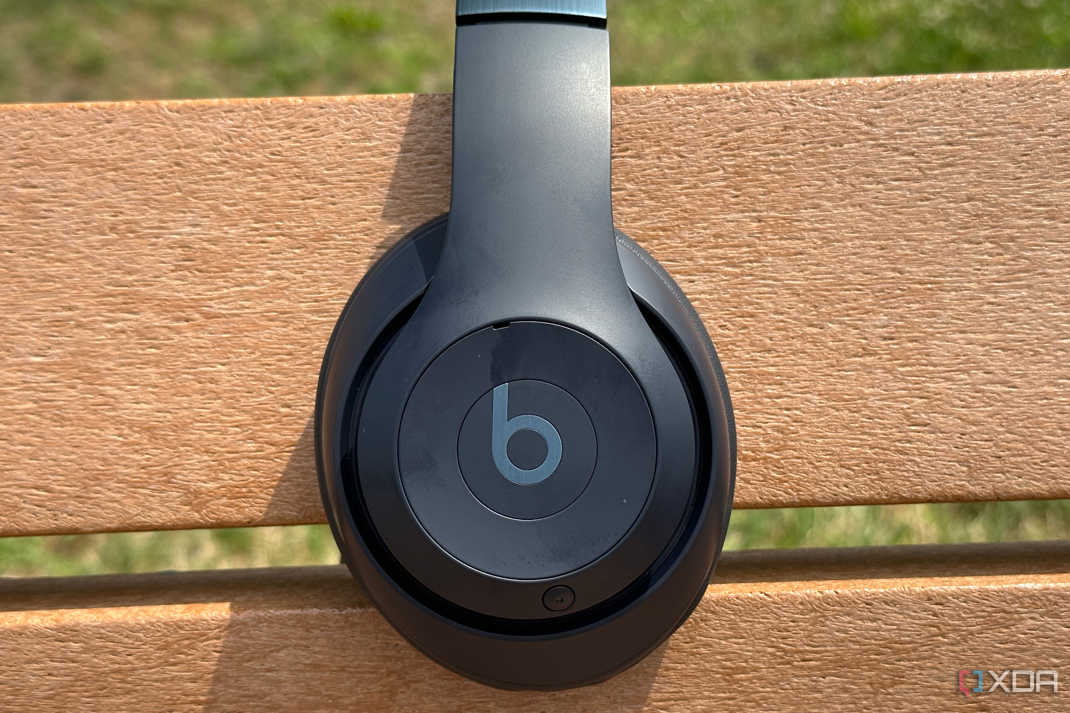 Beats Studio Pro resting on a park bench.