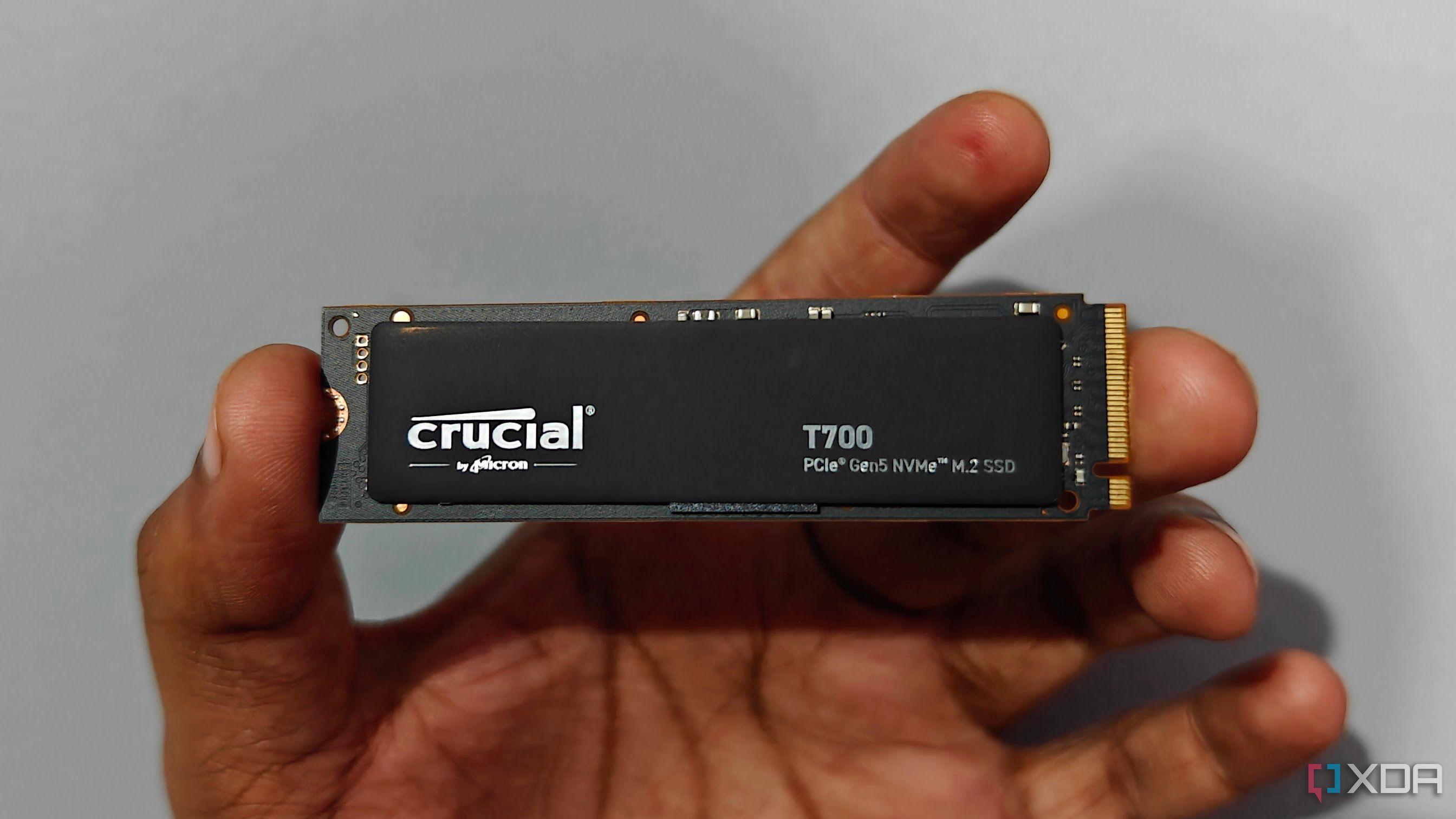 User holding the Crucial T700 SSD in hand