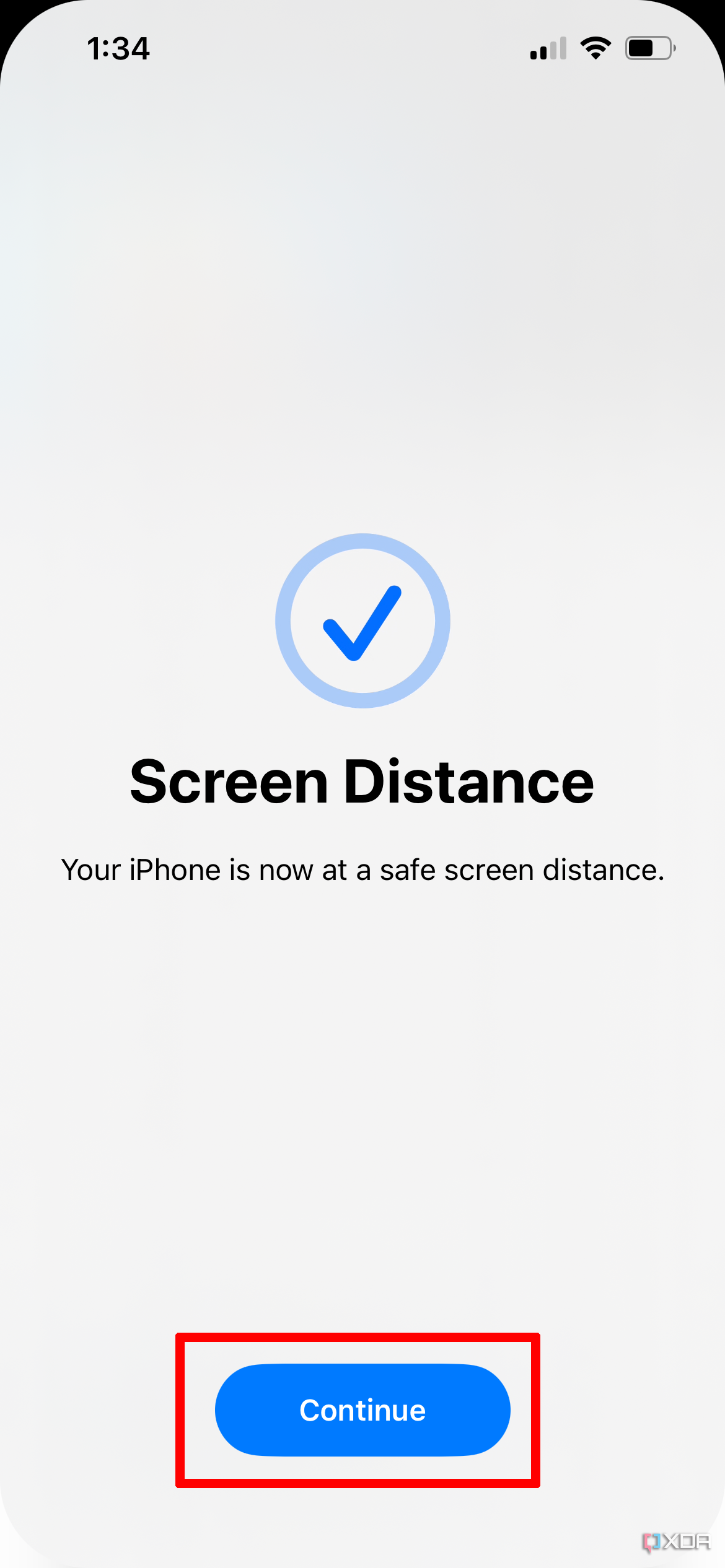 A check mark confirms that you have moved the iPhone far enough for the screen distance.