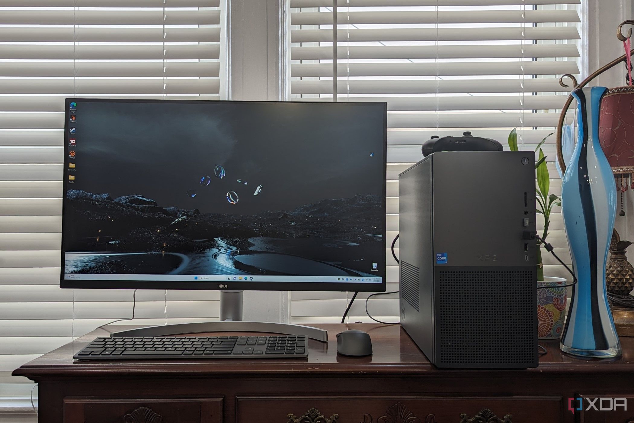 XPS Desktop 8960 sitting on a desk with vases and blinds in the back