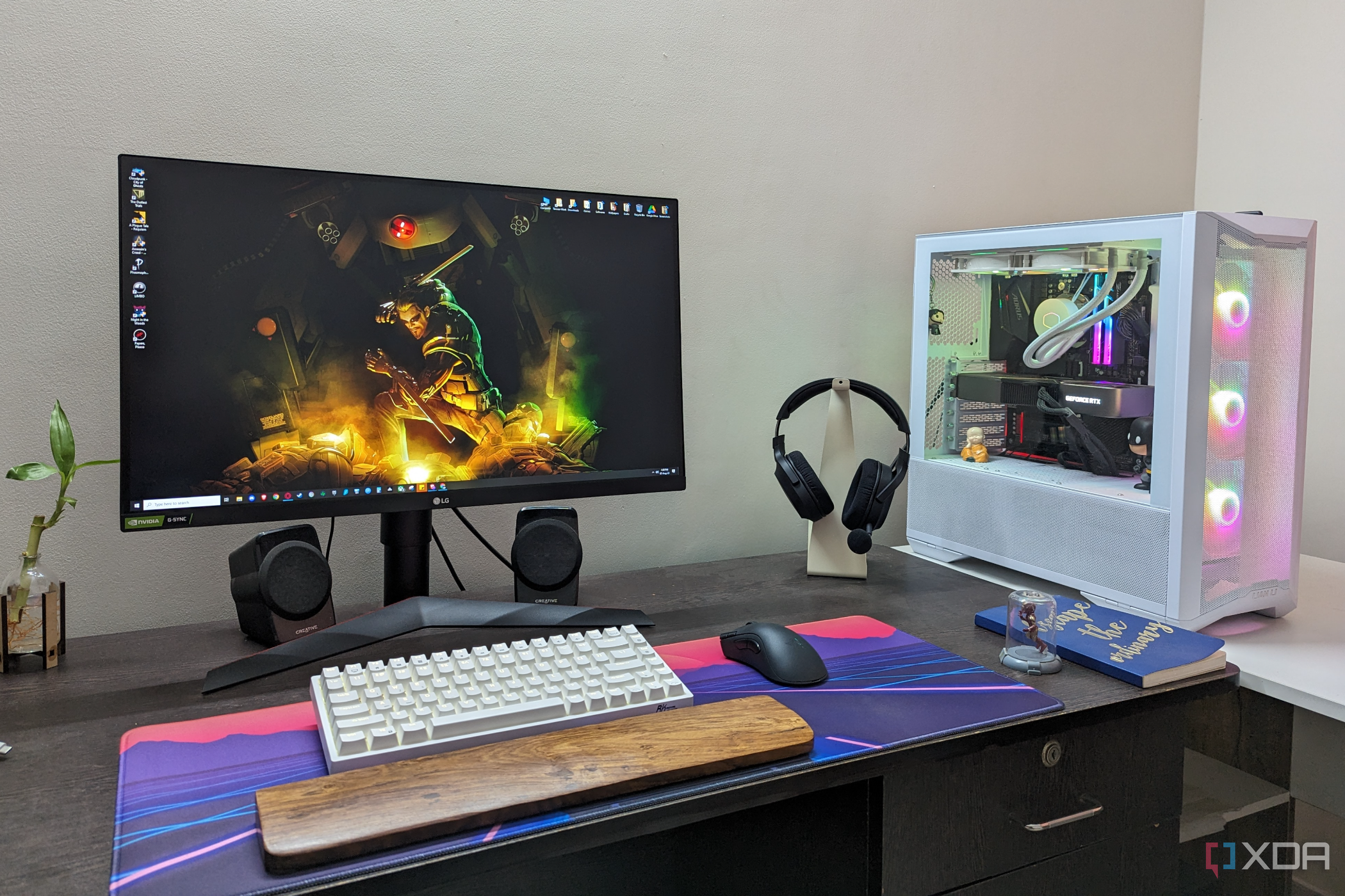 Desktop PC setup showing a gaming PC, monitor, keyboard, mouse, and headset