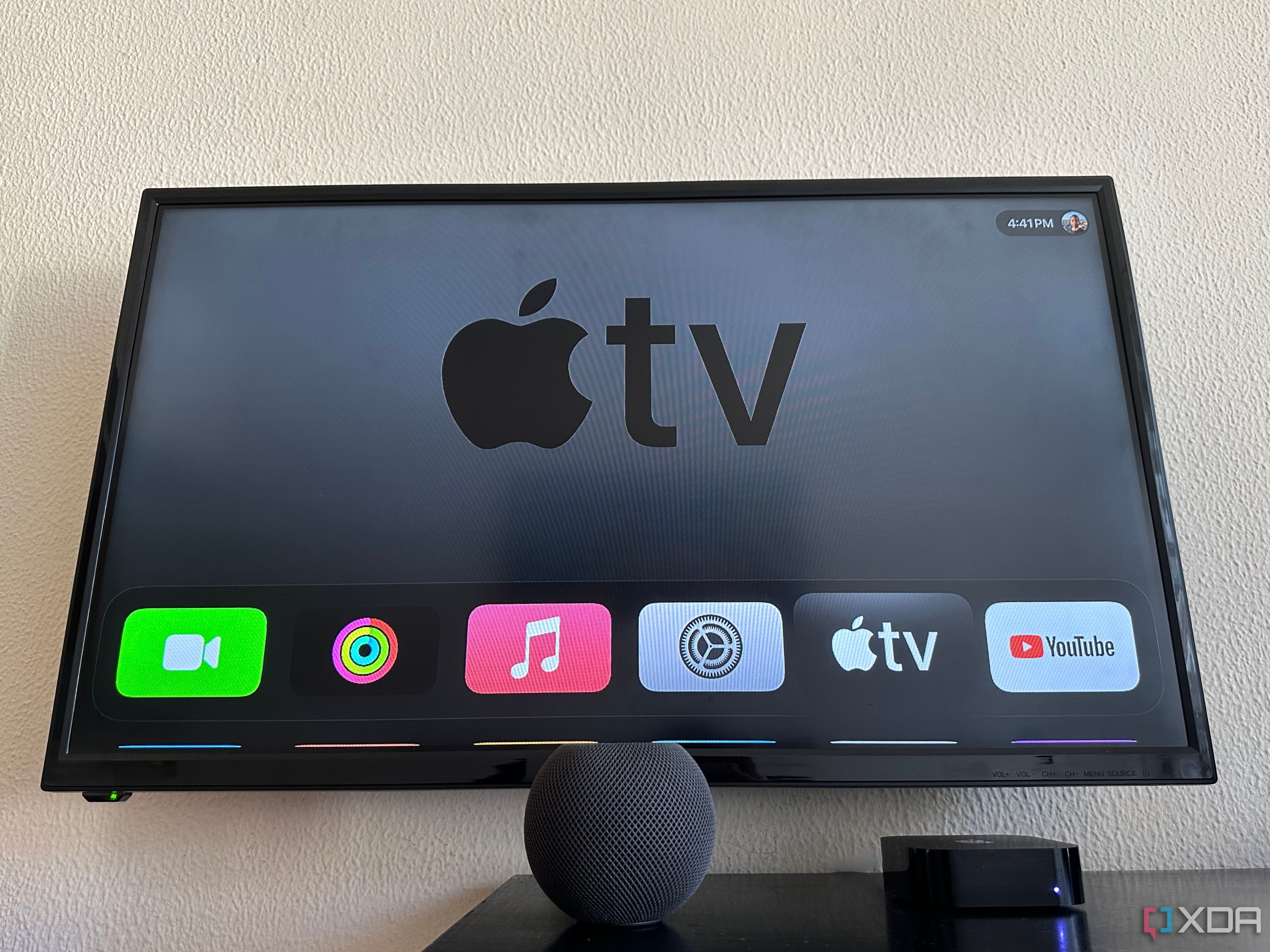 Apple TV 4K 3 next to HomePod Mini on a table with Apple TV displayed on the screen