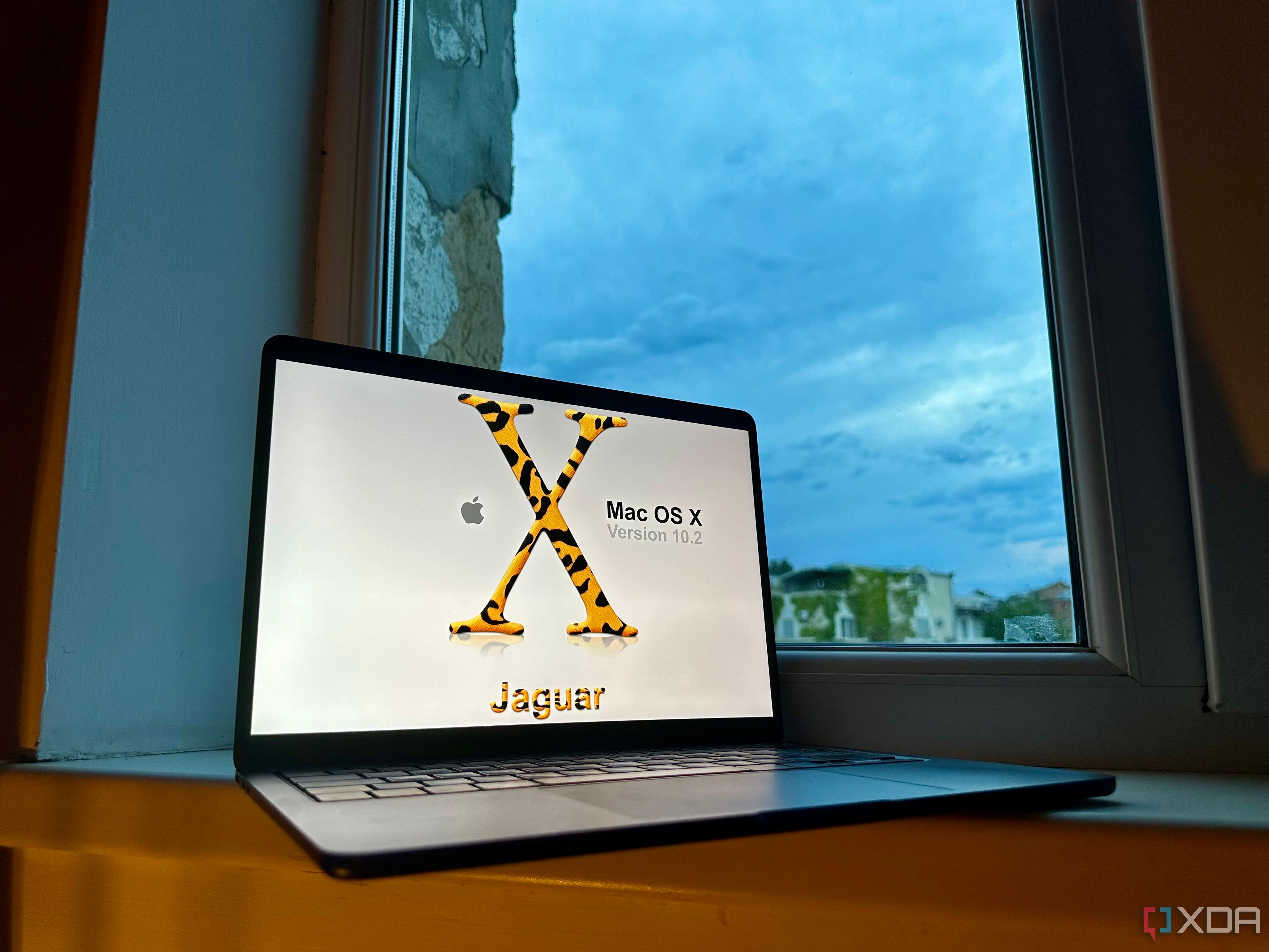 Photo of Mac OS X Jaguar promo displayed on MacBook Air M2