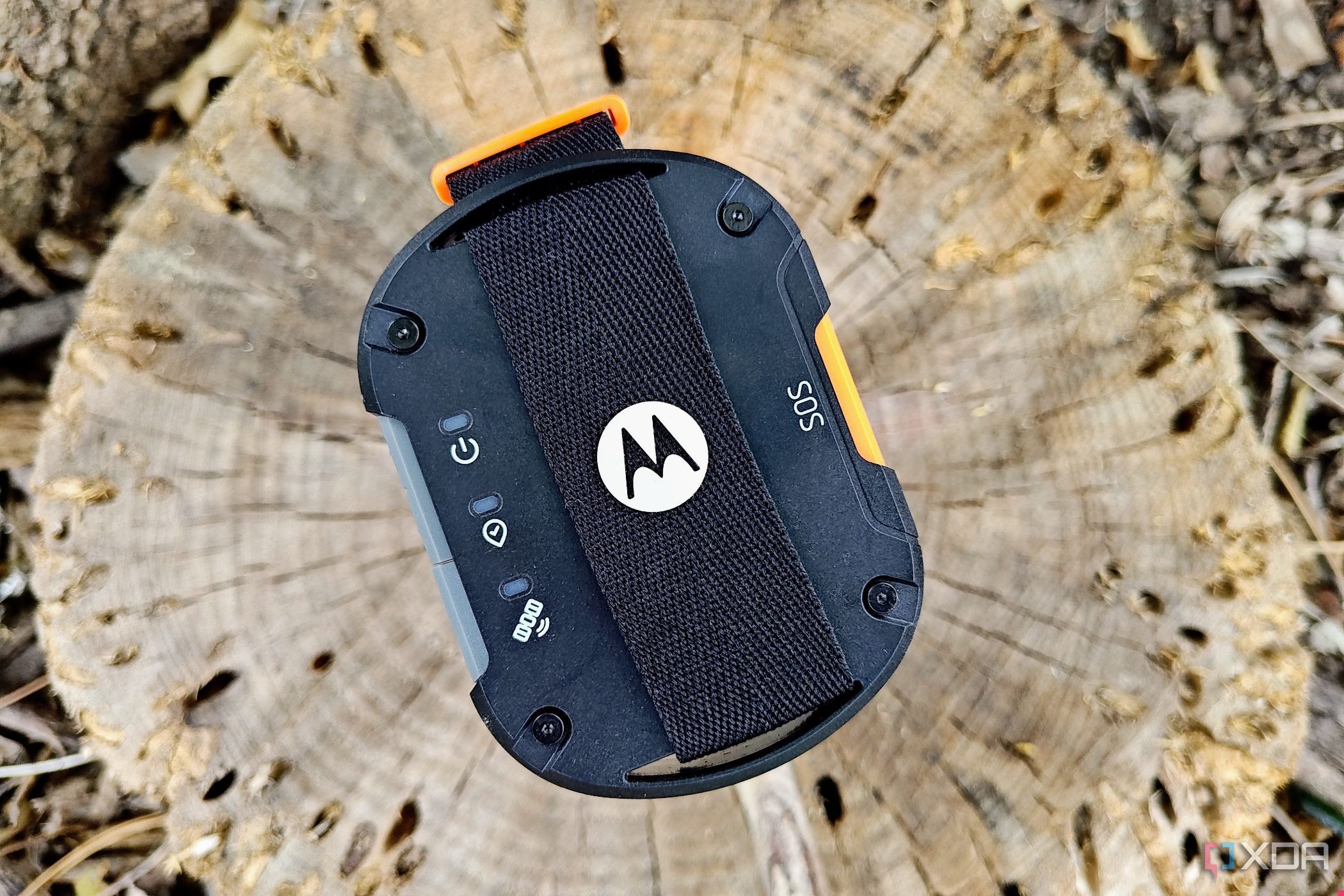 Motorola Defy Satellite Link sitting on a log