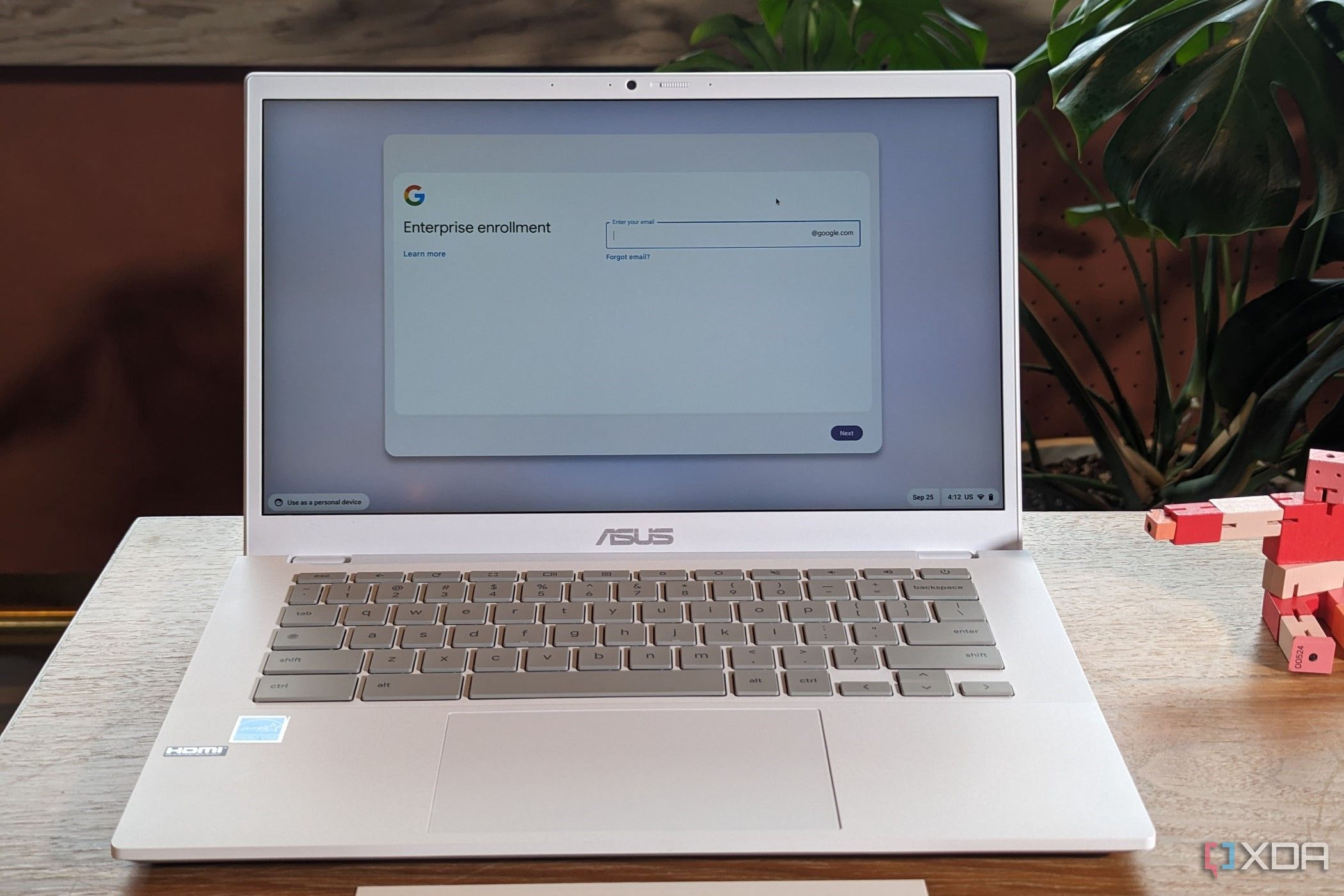 Acer Chromebook Plus CX34 on a desk with a  robot figure in the back