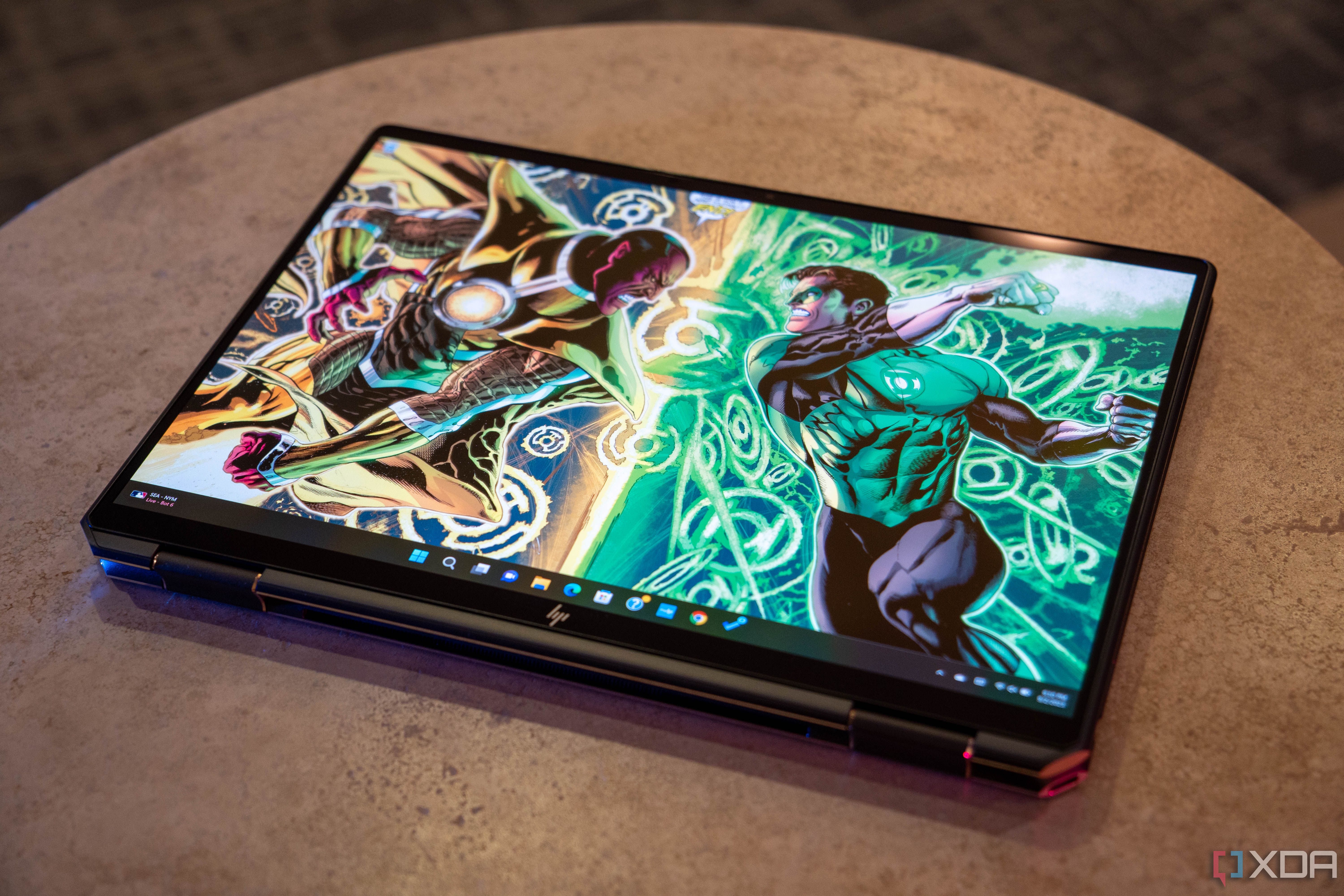 HP laptop in tablet mode with Green Lantern and Sinestro wallpaper