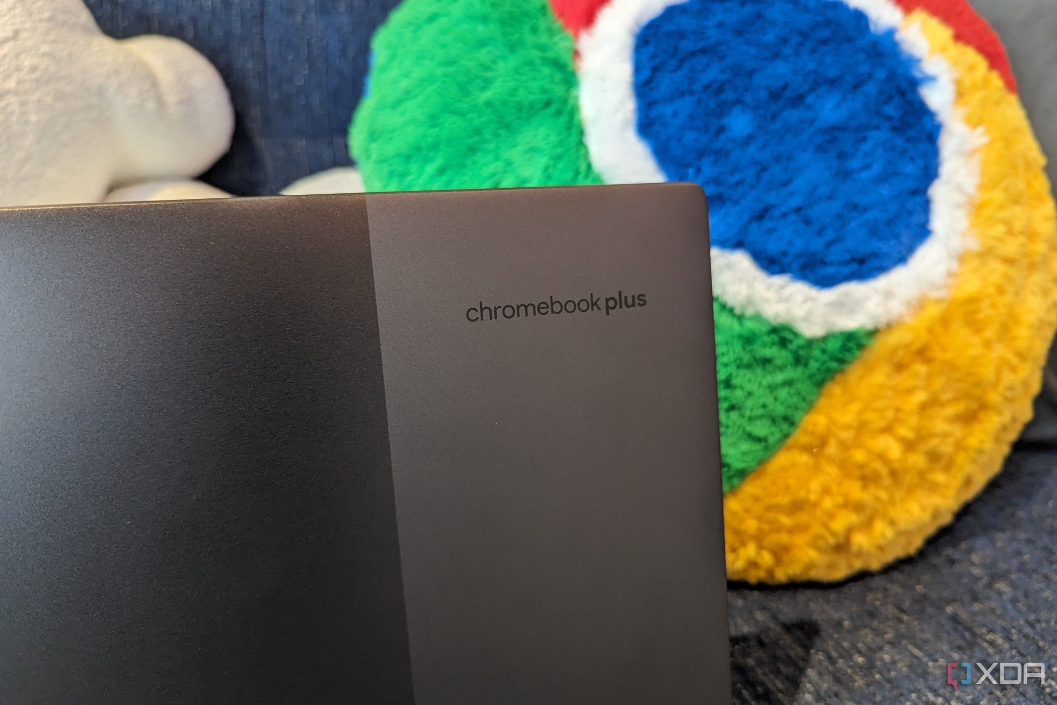 A Lenovo Chromebook Plus model with the Google Chrome pillow in the back