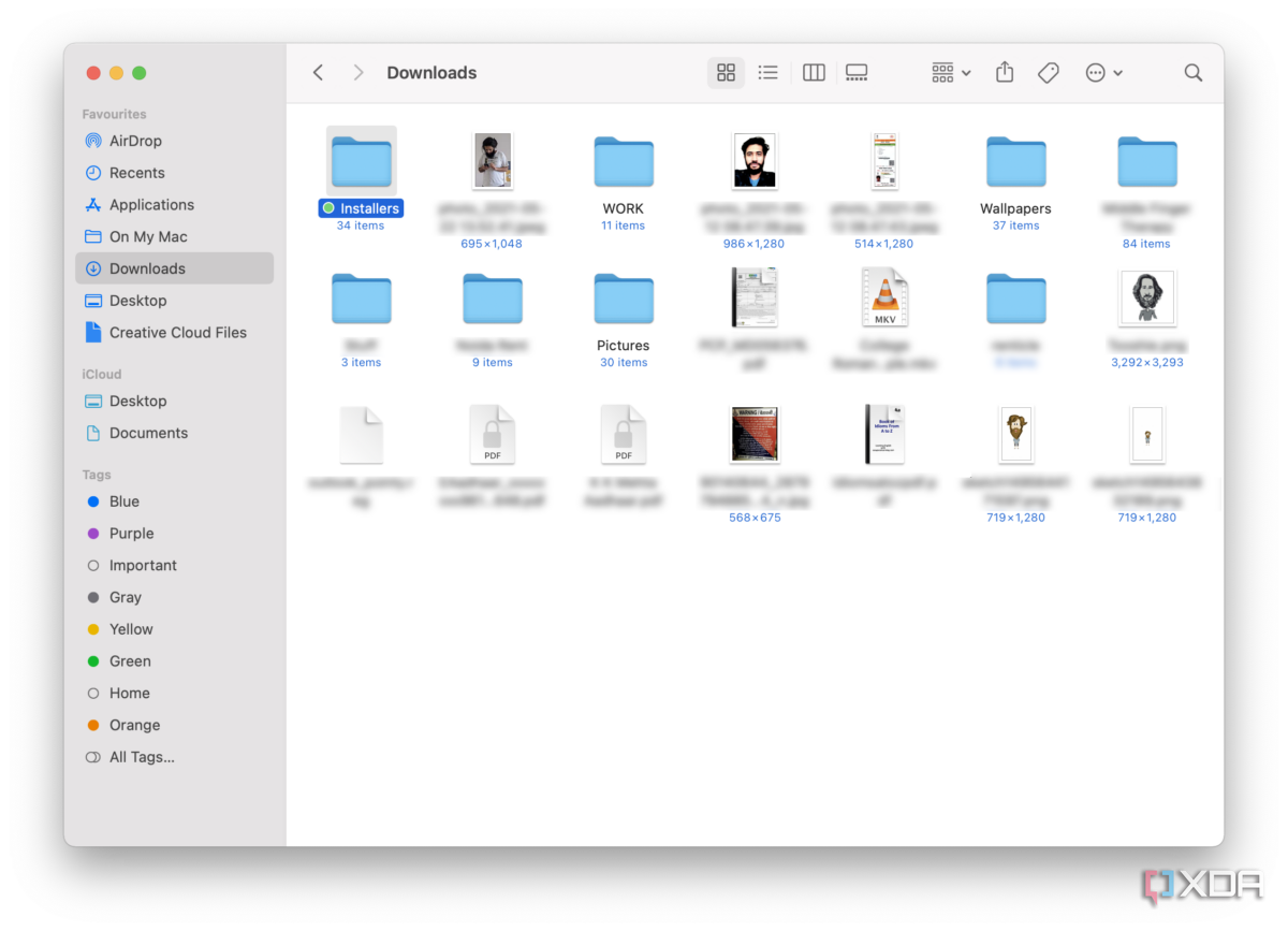 Finder on macOS showing downloads folder with a wide variety of files