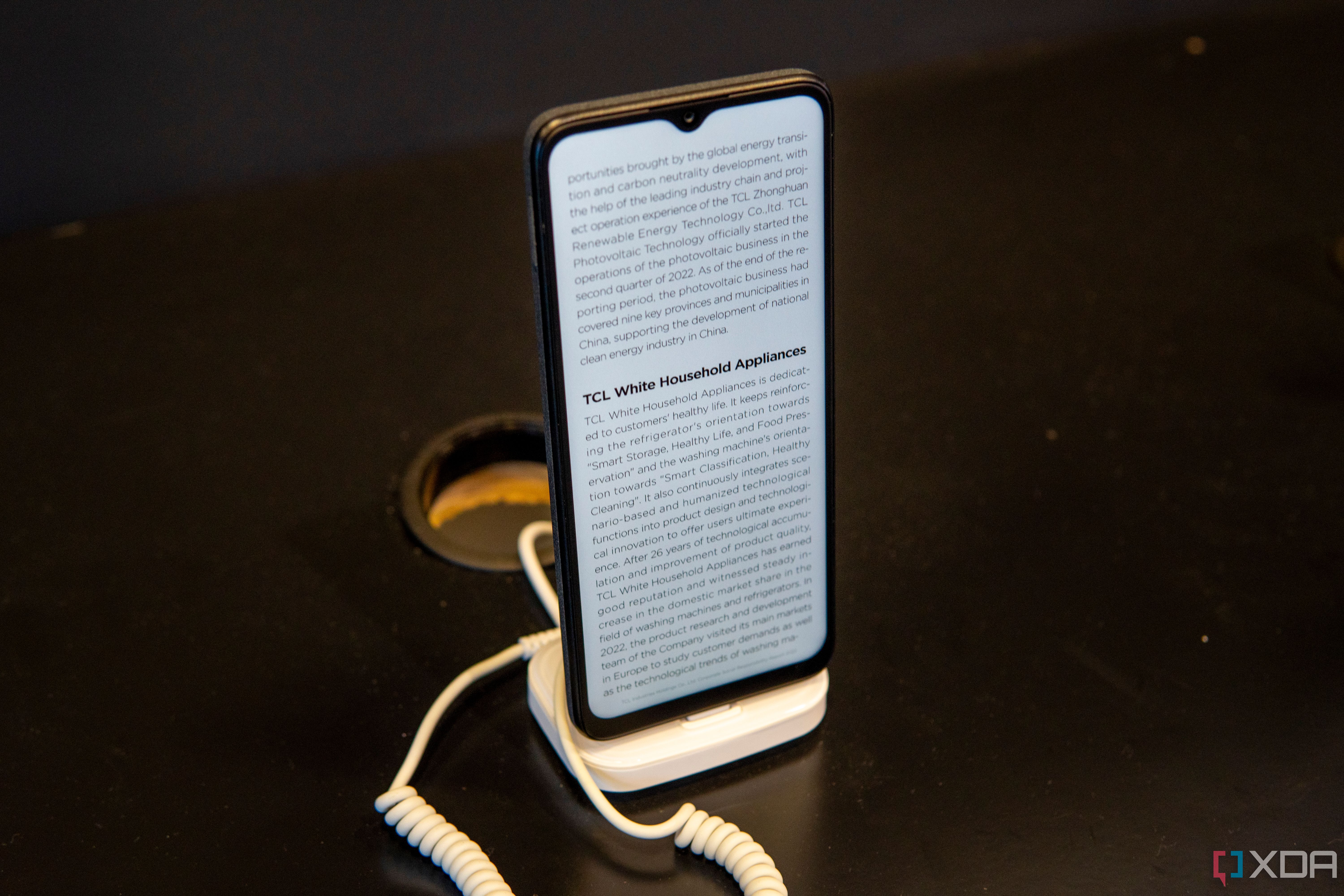 Angled view of the TCL 40 NXTPAPER on a display stand displaying text
