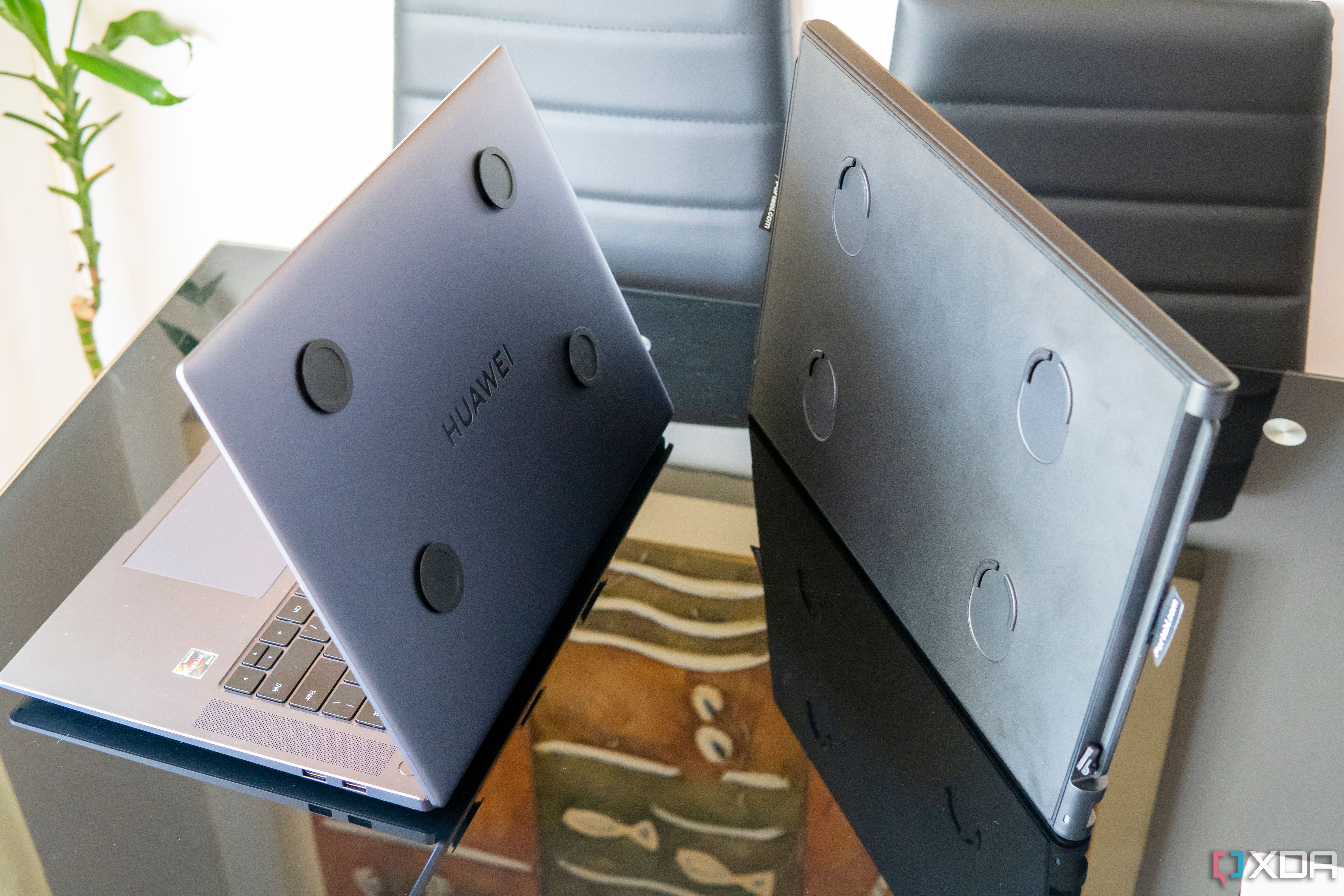 A Slide V2 unit next to a laptop with the respective mounting pads attached