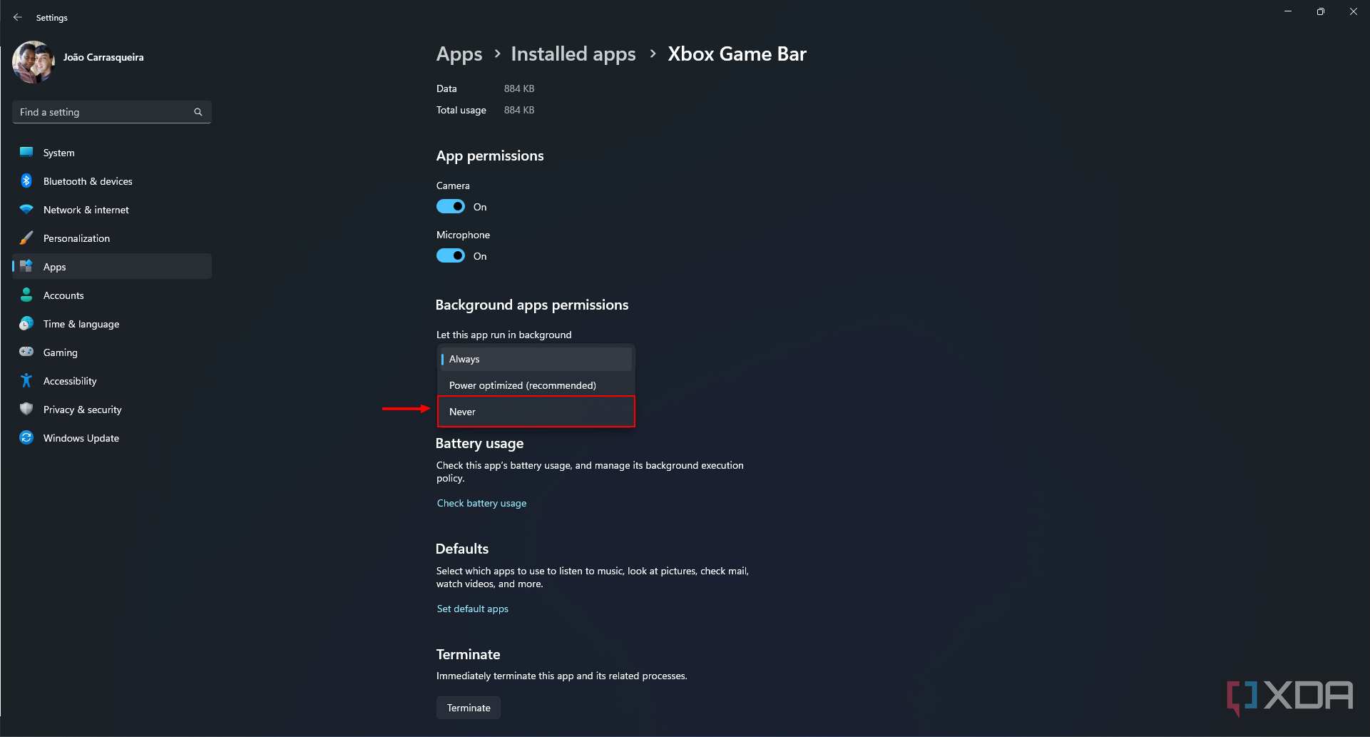 Screenshot of the Xbox Game Bar app settings on Windows 11 with the background permissions dropdown menu open. The Never option is highlighted