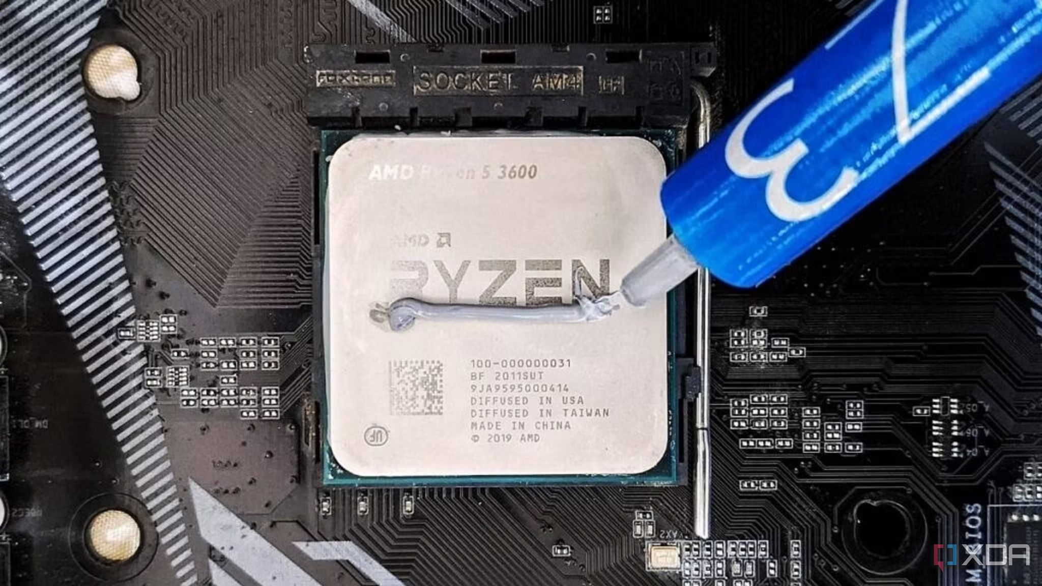 An photo showing an AMD Ryzen 5 3600 CPU with thermal paste.
