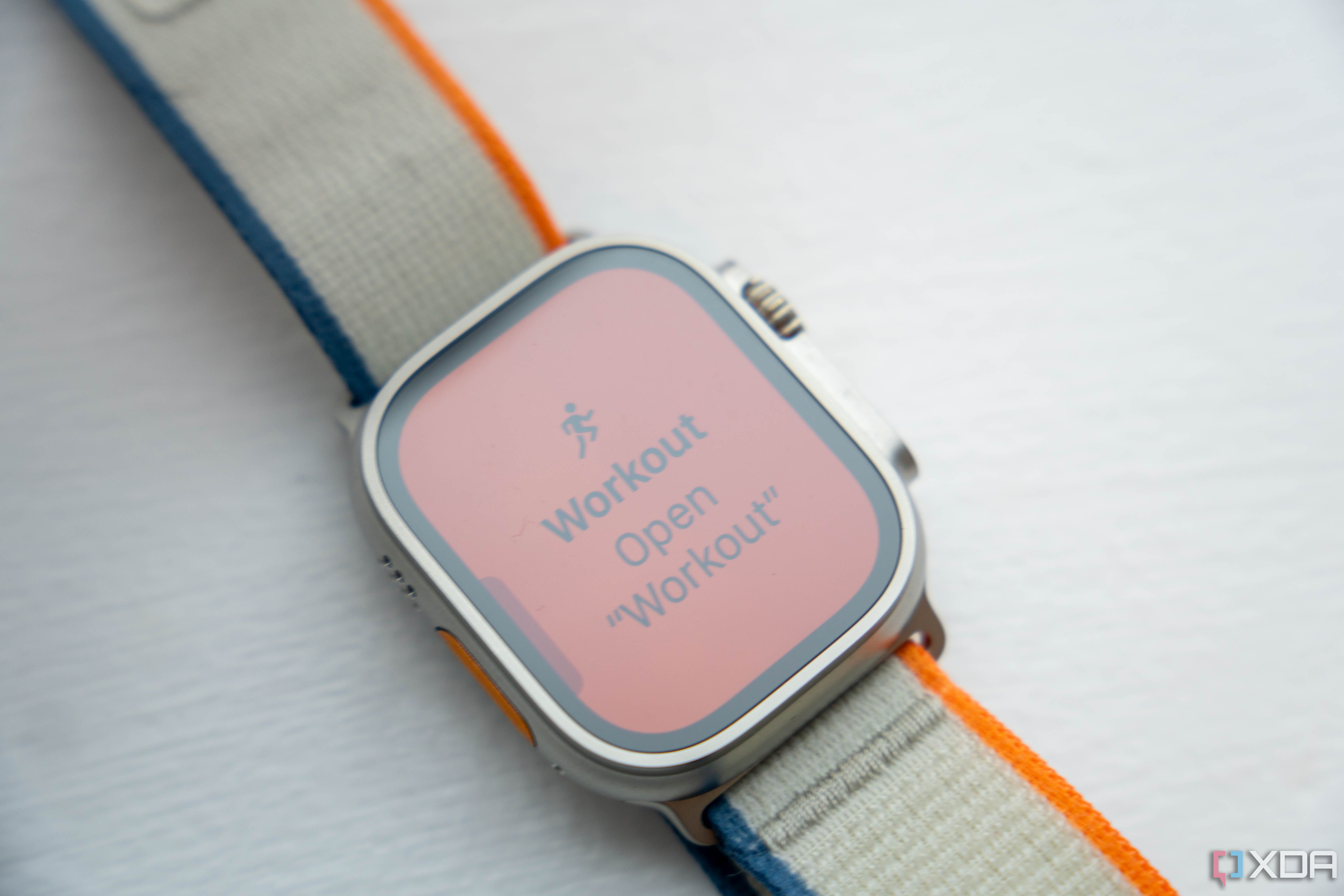Apple Watch Ultra 2 showing Workout Open Workout text on orange background