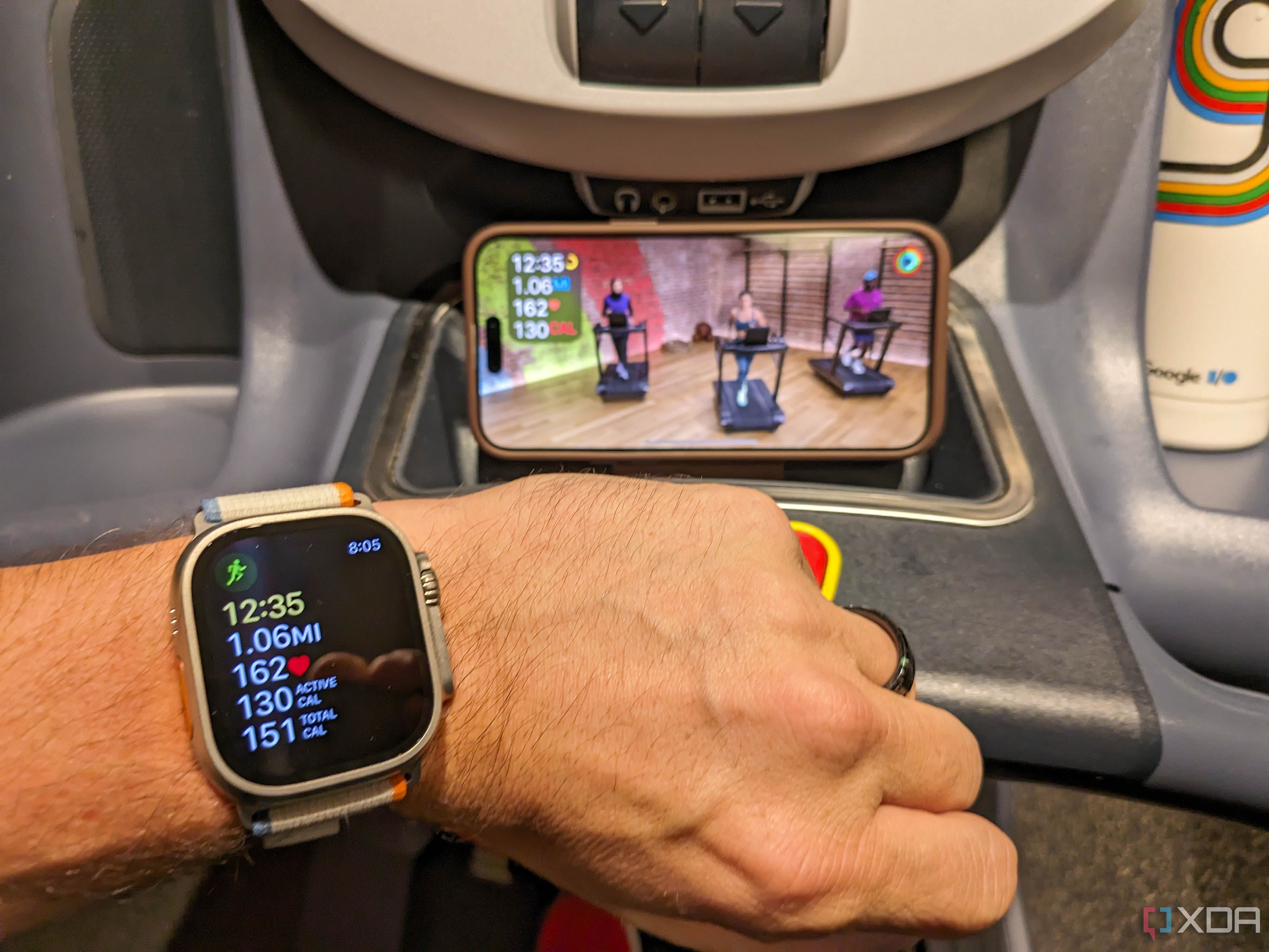 Apple Watch with treadmill workout on display in background