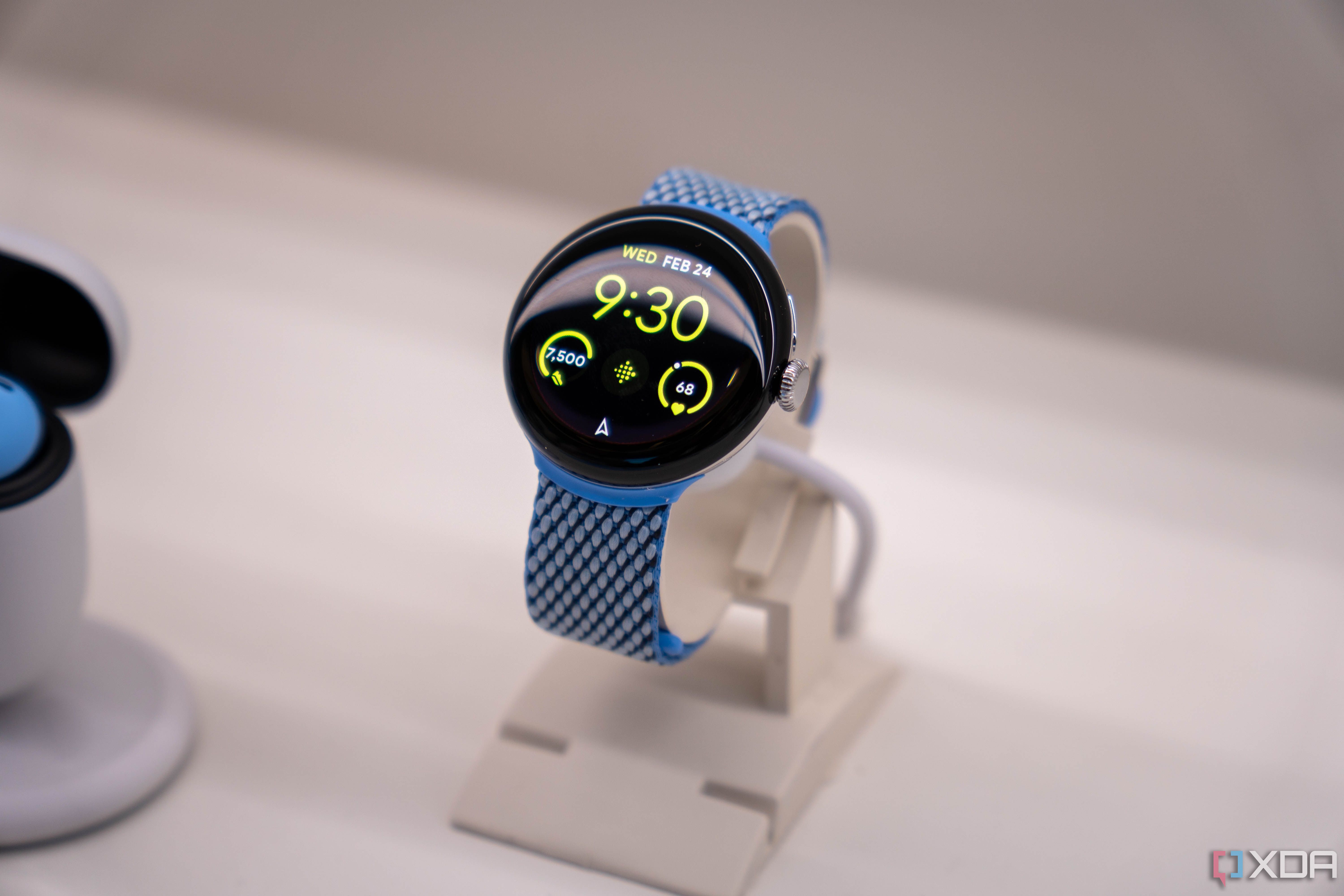 The silver Google Pixel Watch 2 on a stand. 