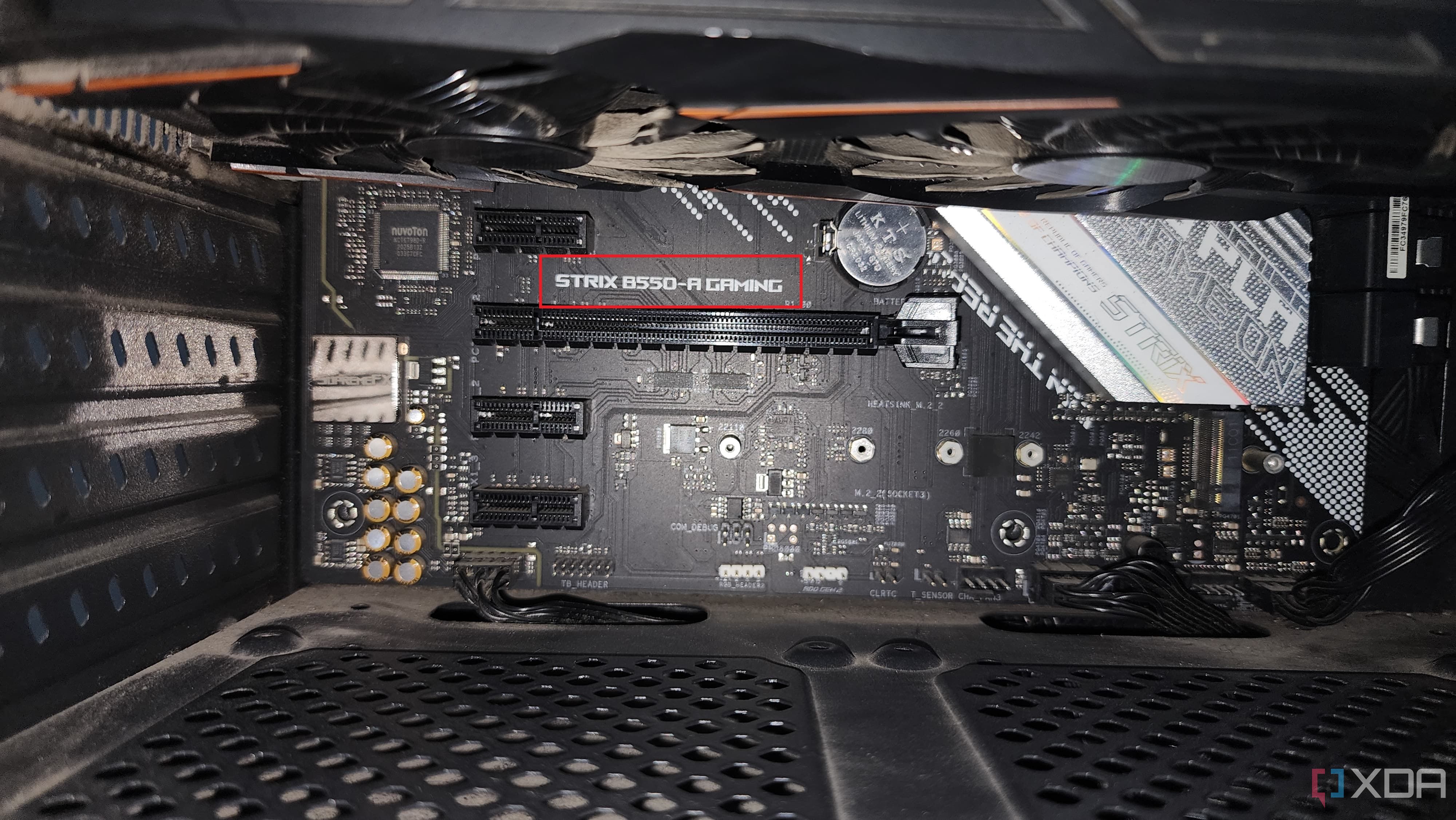 picture of a motherboard with its name highlighted and a gpu on top