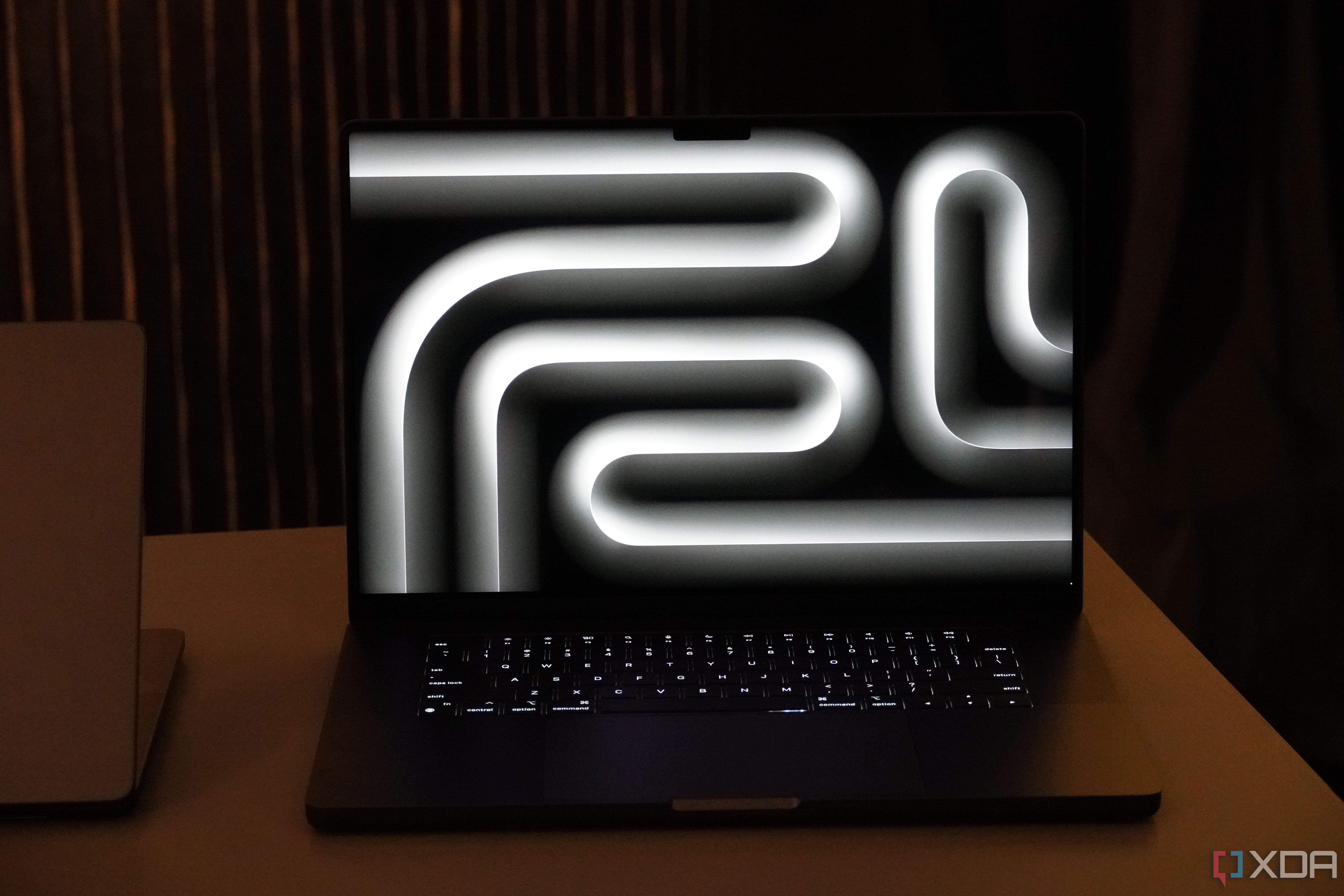 The wallpaper of the M3 MacBook Pro in Space Black.