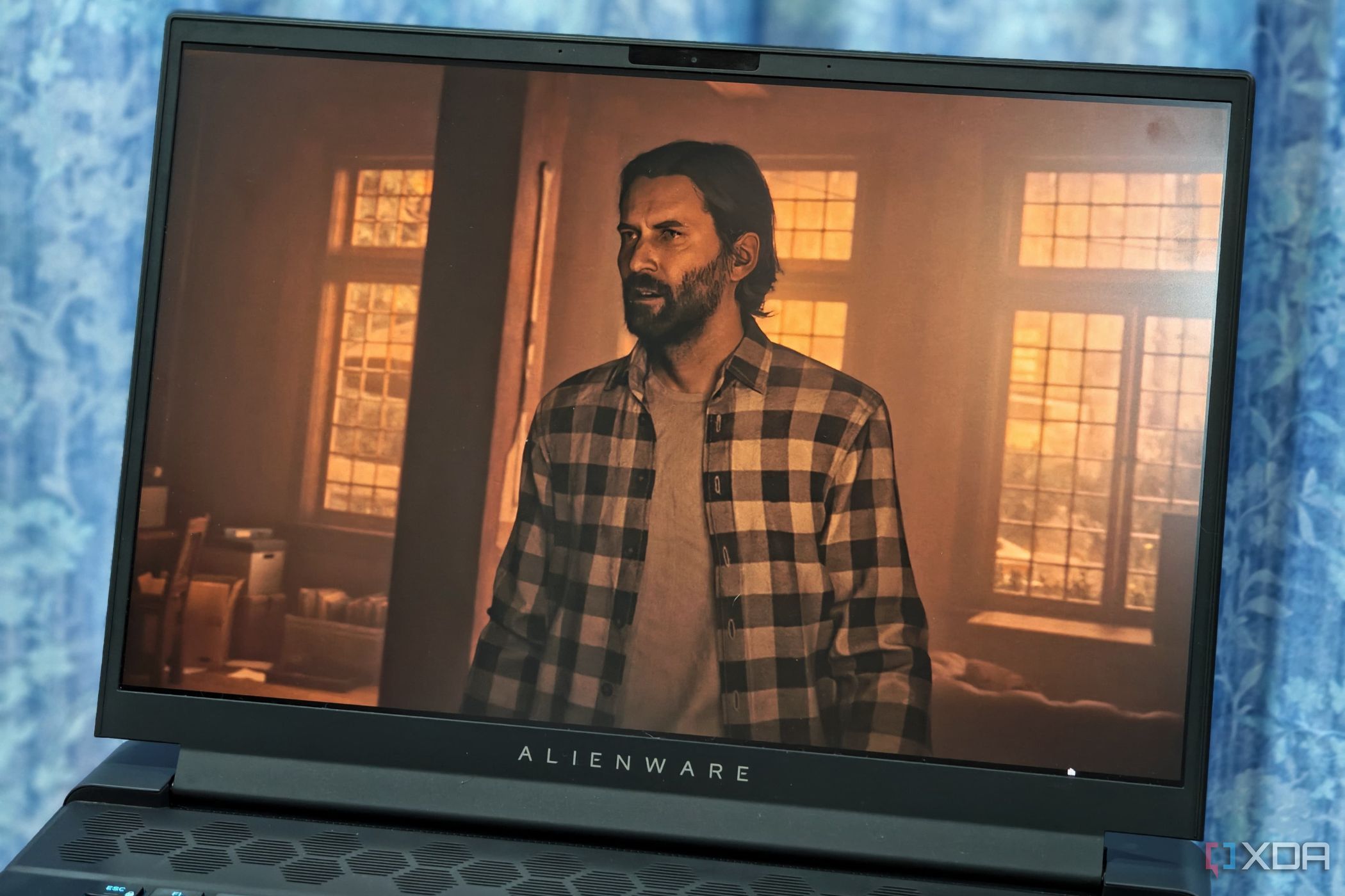 An image showing the Alienware m16 display with Alan Wake 2's screenshot on it.