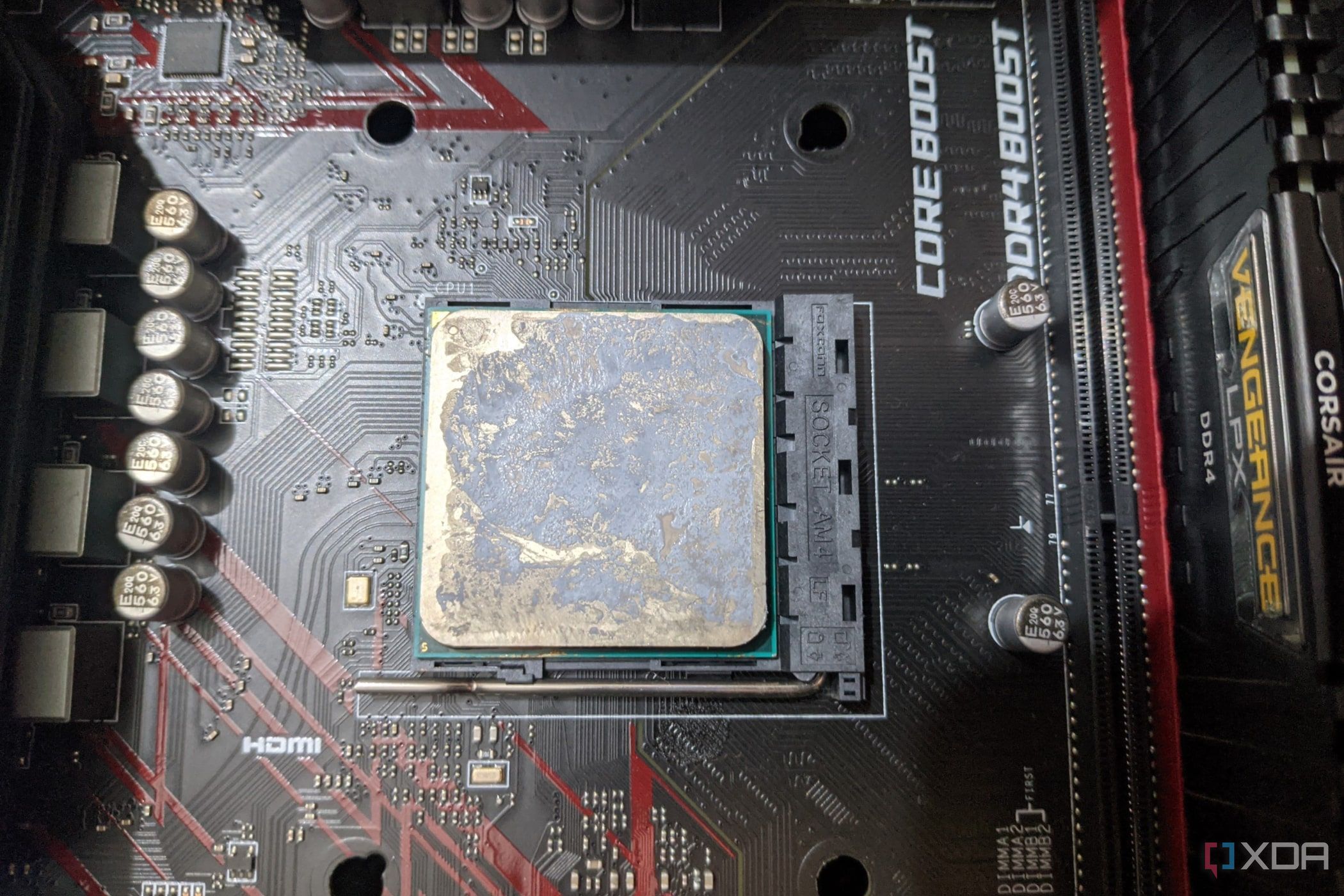 An image of the AMD Ryzen 1600 with thermal paste smeared all over it