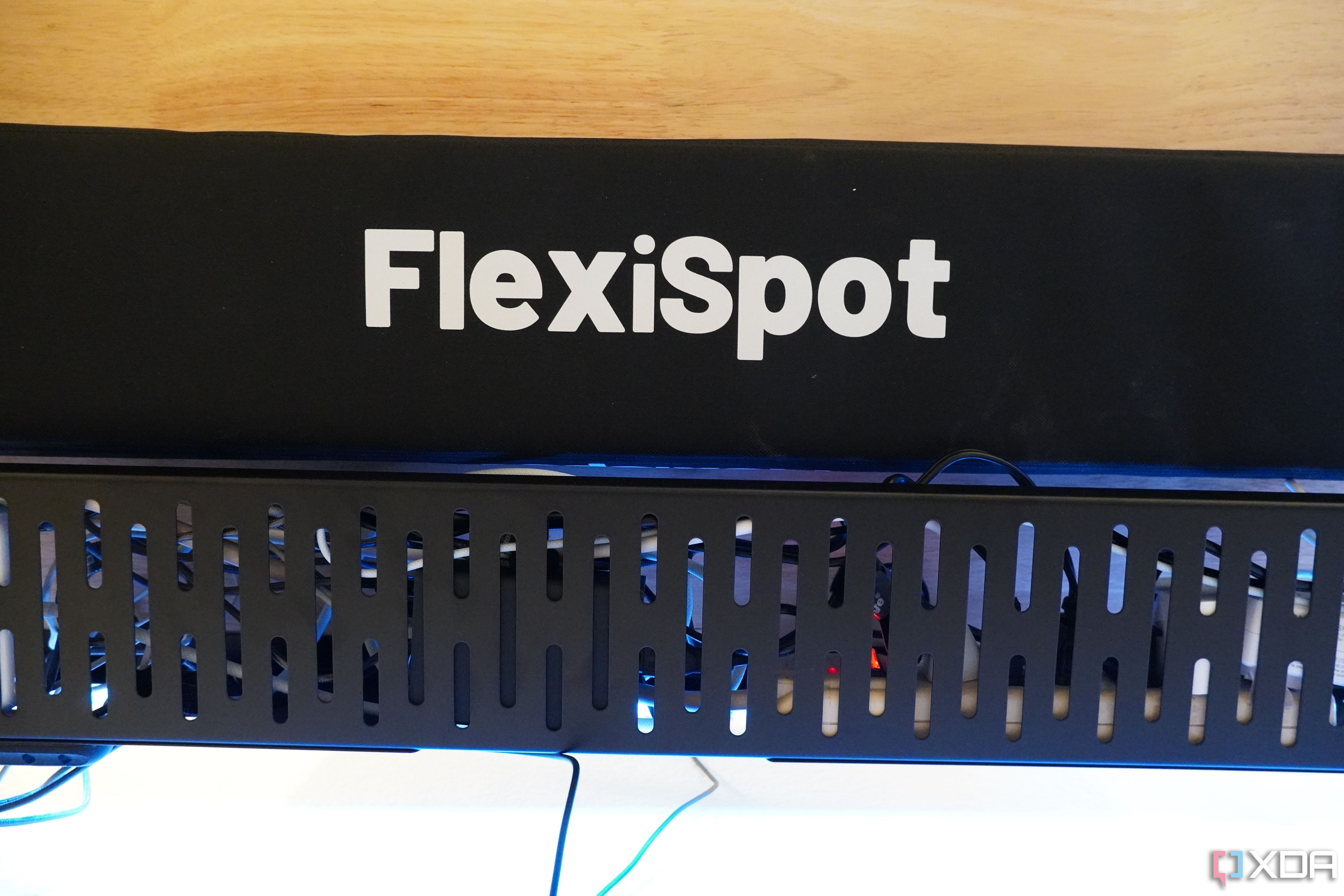 The FlexiSpot cable management tray and sleeve.