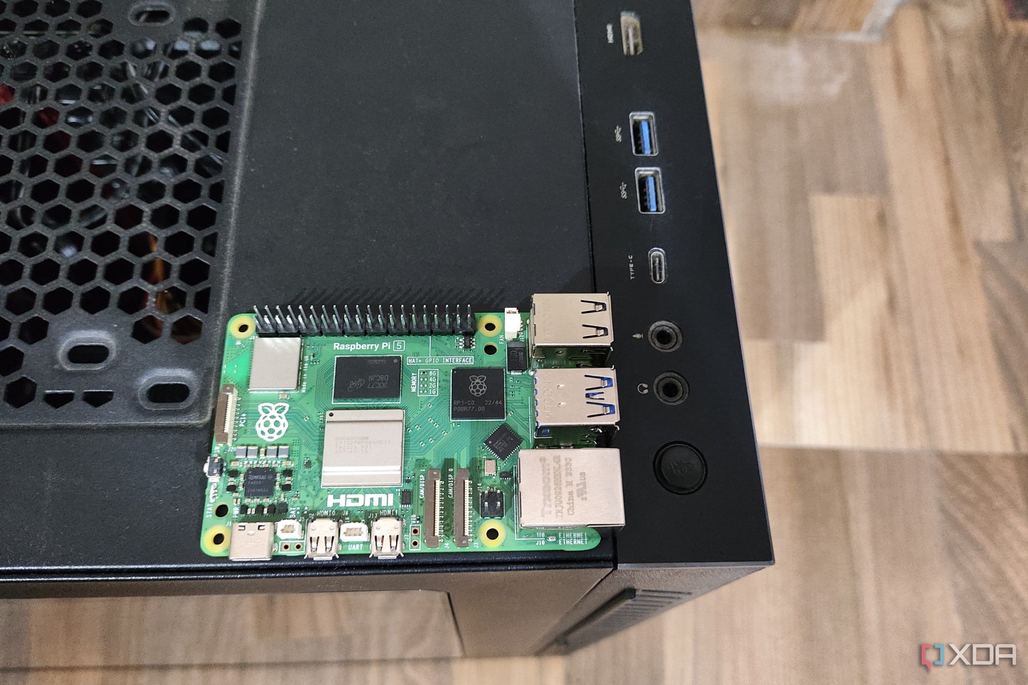 A Raspberry Pi 5 placed on a Gigabyte Aorus AC300W cabinet