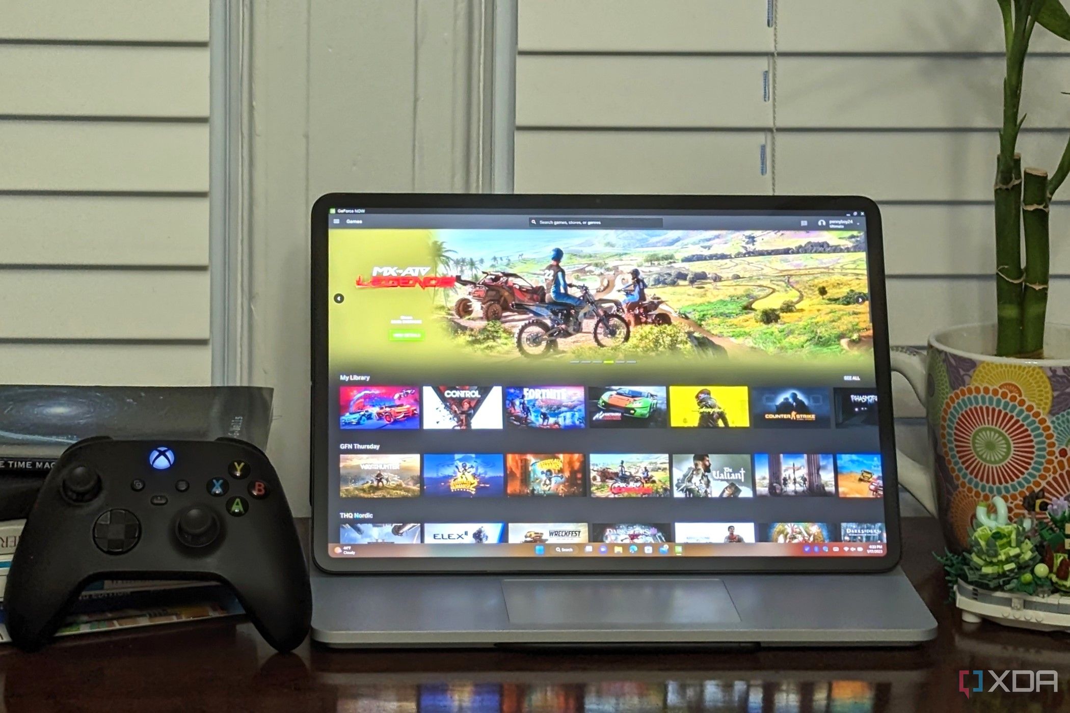 Nvidia GeForce Now Ultimate running on a laptop next to an xbox controller