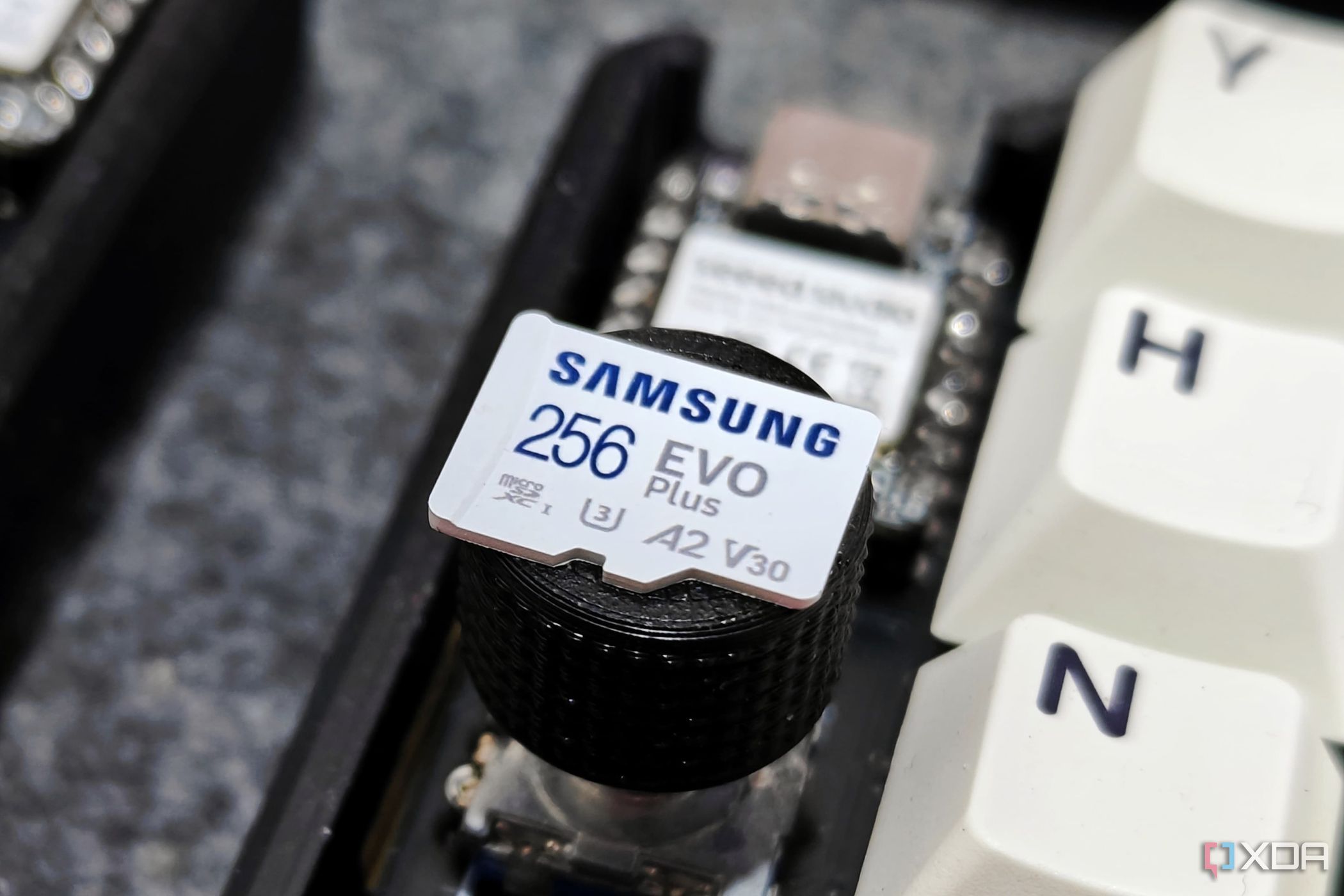 An image showing a Samsung EVO Plus SDXC V30 card placed on a rotary knob of a keyboard.