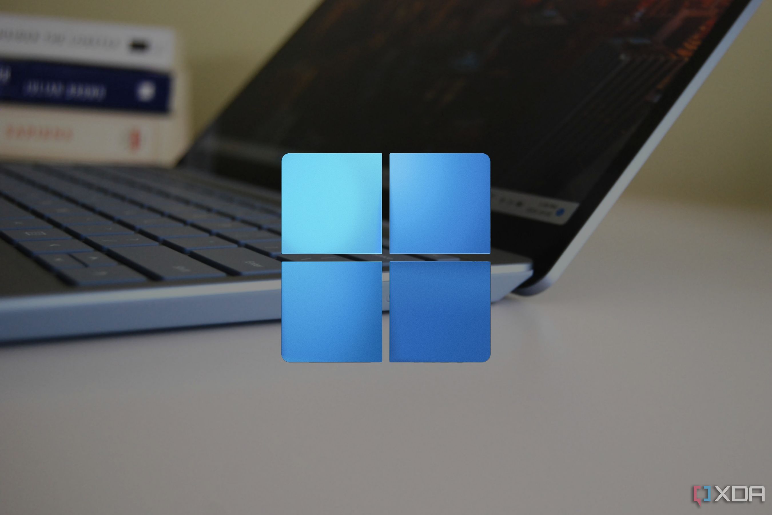 Close-up view of a Surface Laptop Go 3 with the Windows 11 logo overlaid on top