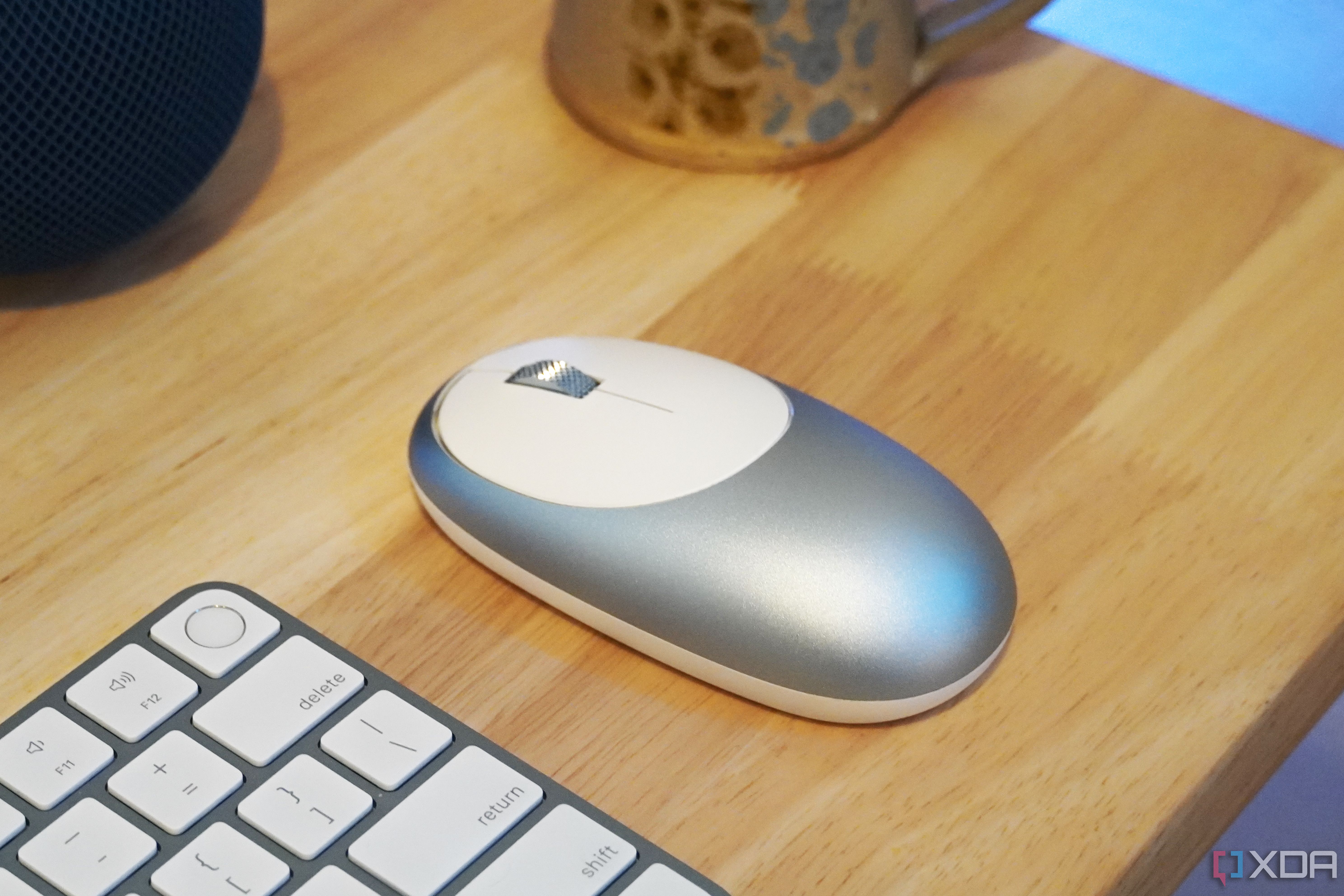 Синяя мышь M1 на столе с клавиатурой.