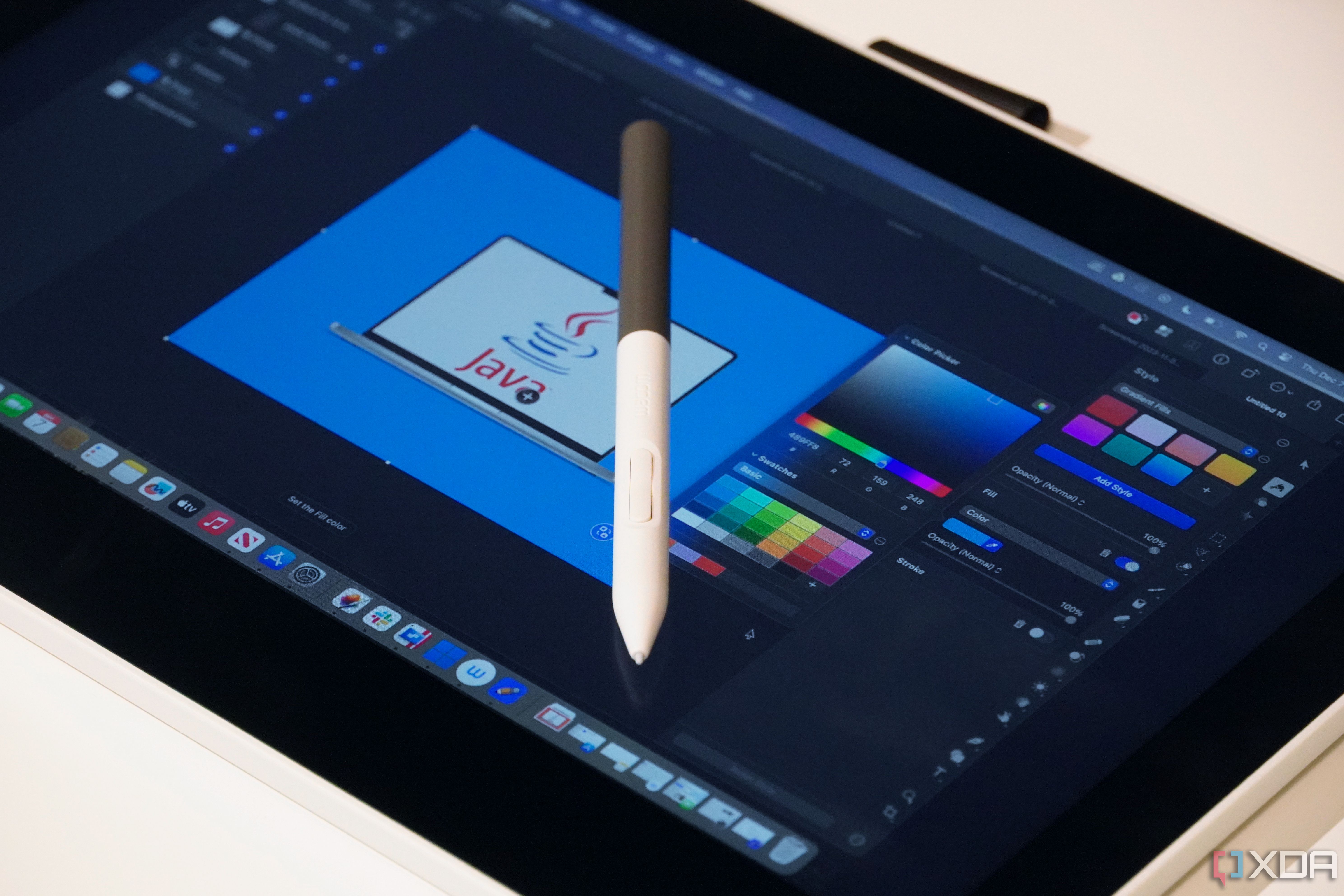 A Wacom One running Pixelmator Pro with a pen on the display.