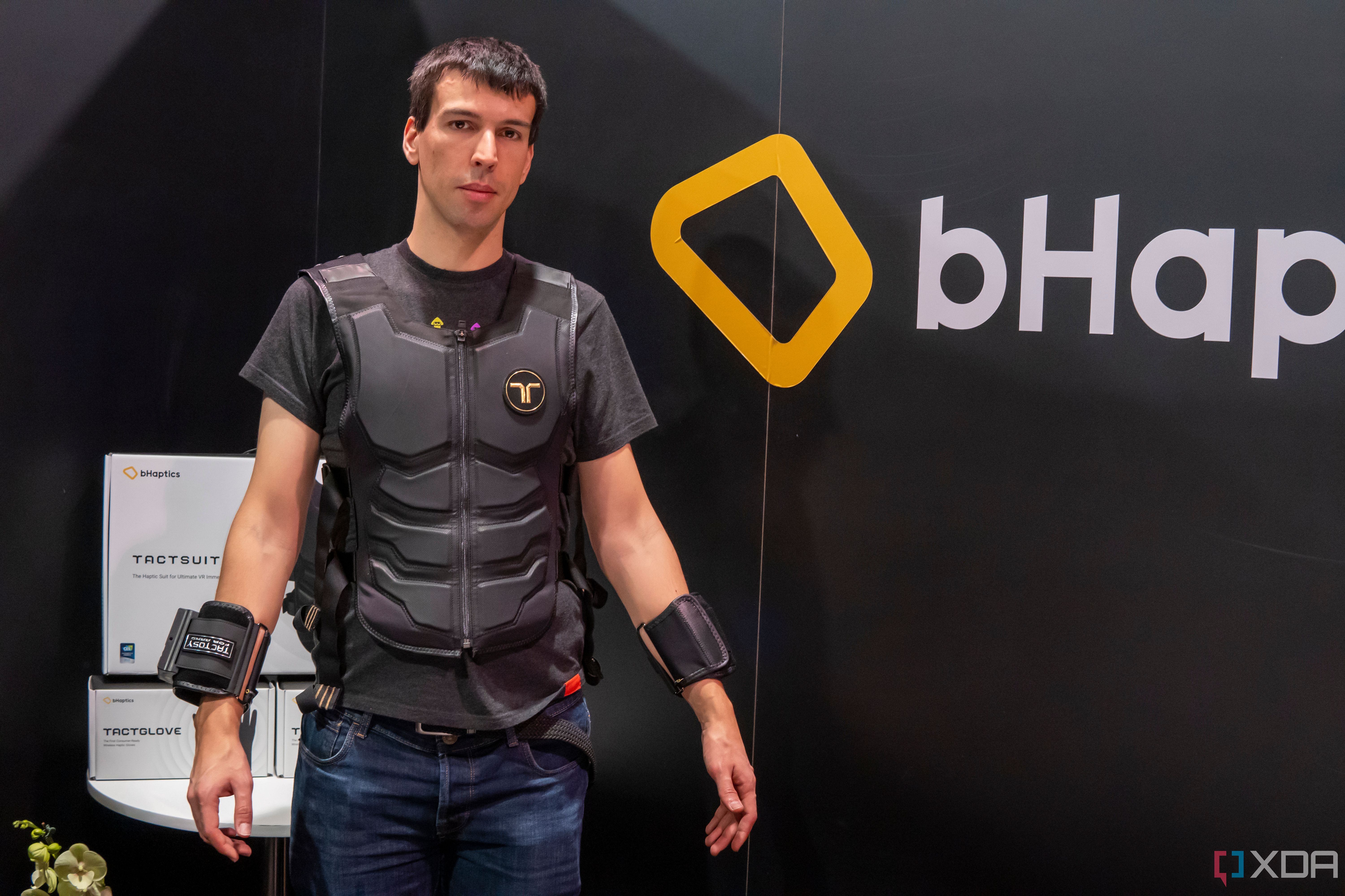 Man wearing a haptic feedback suit and arm bands