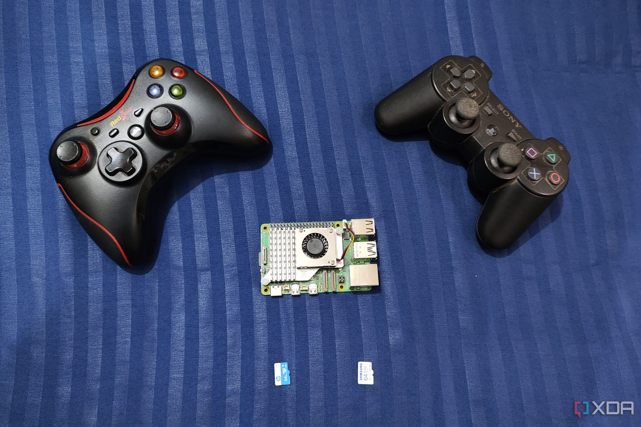 An image of the Raspberry Pi 5 with two controllers and two microSD cards nearby