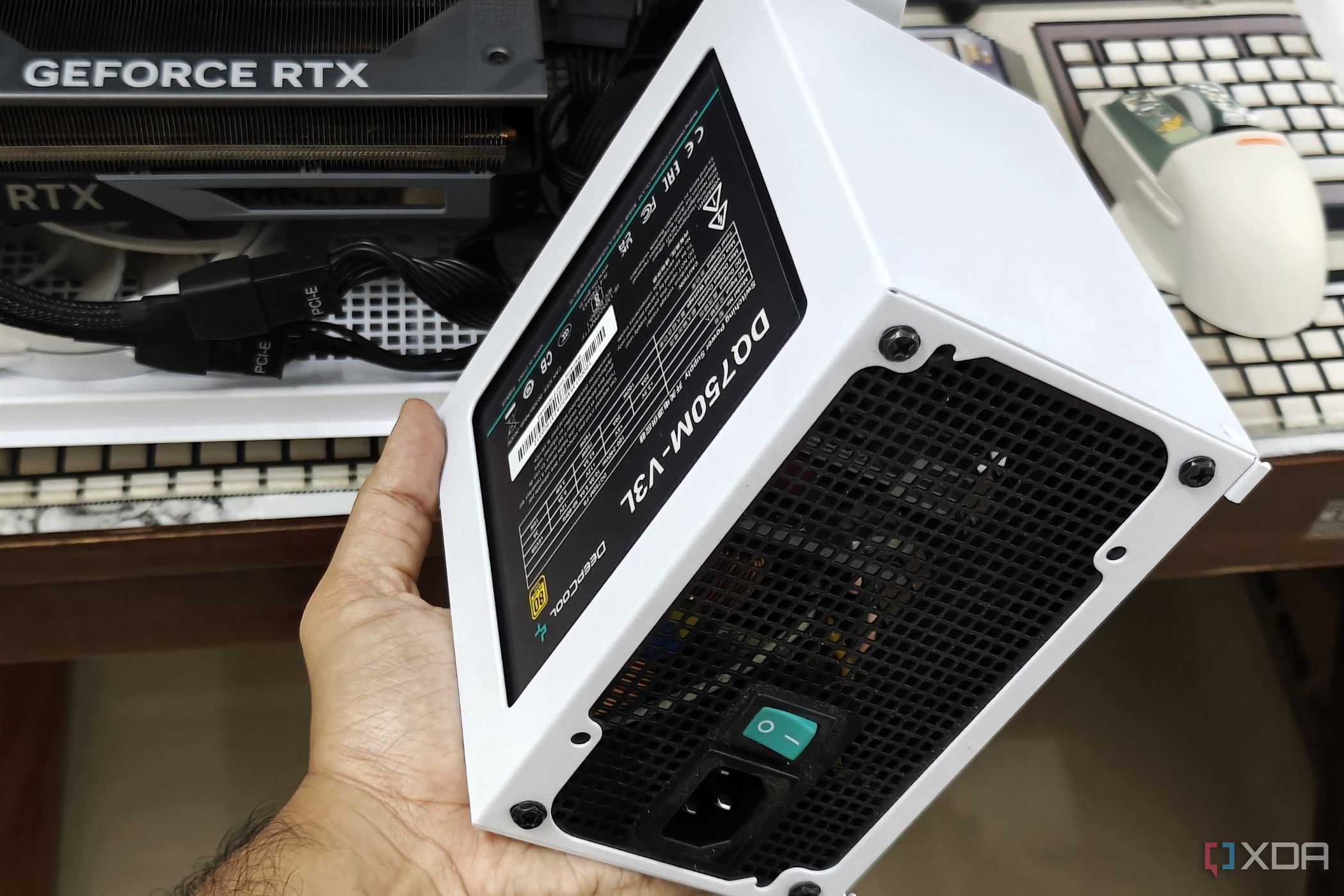 An image showing a person holding the PSU shroud with a PSU in hand.