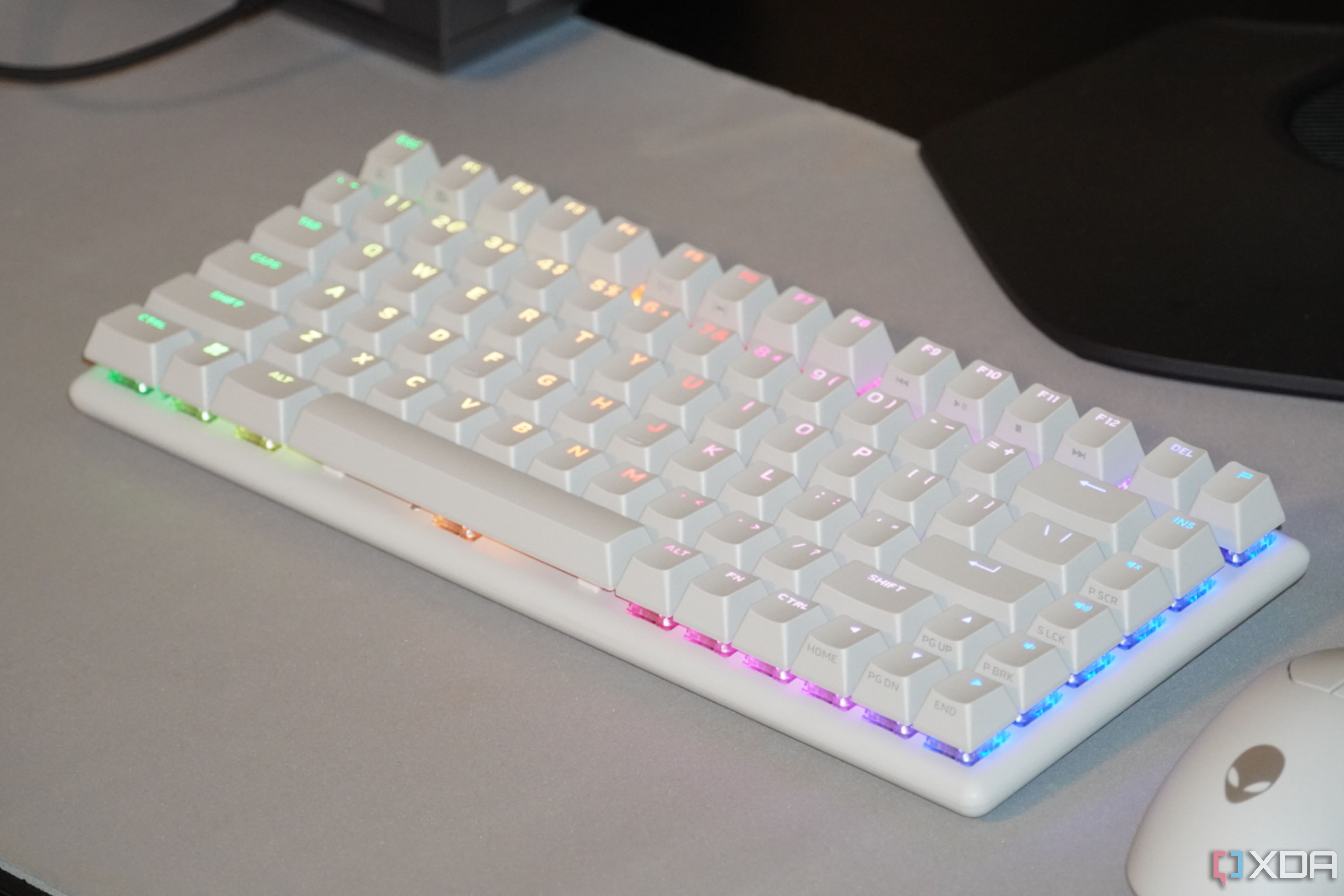The Alienware Pro wireless keyboard on a desk with RGB lighting.