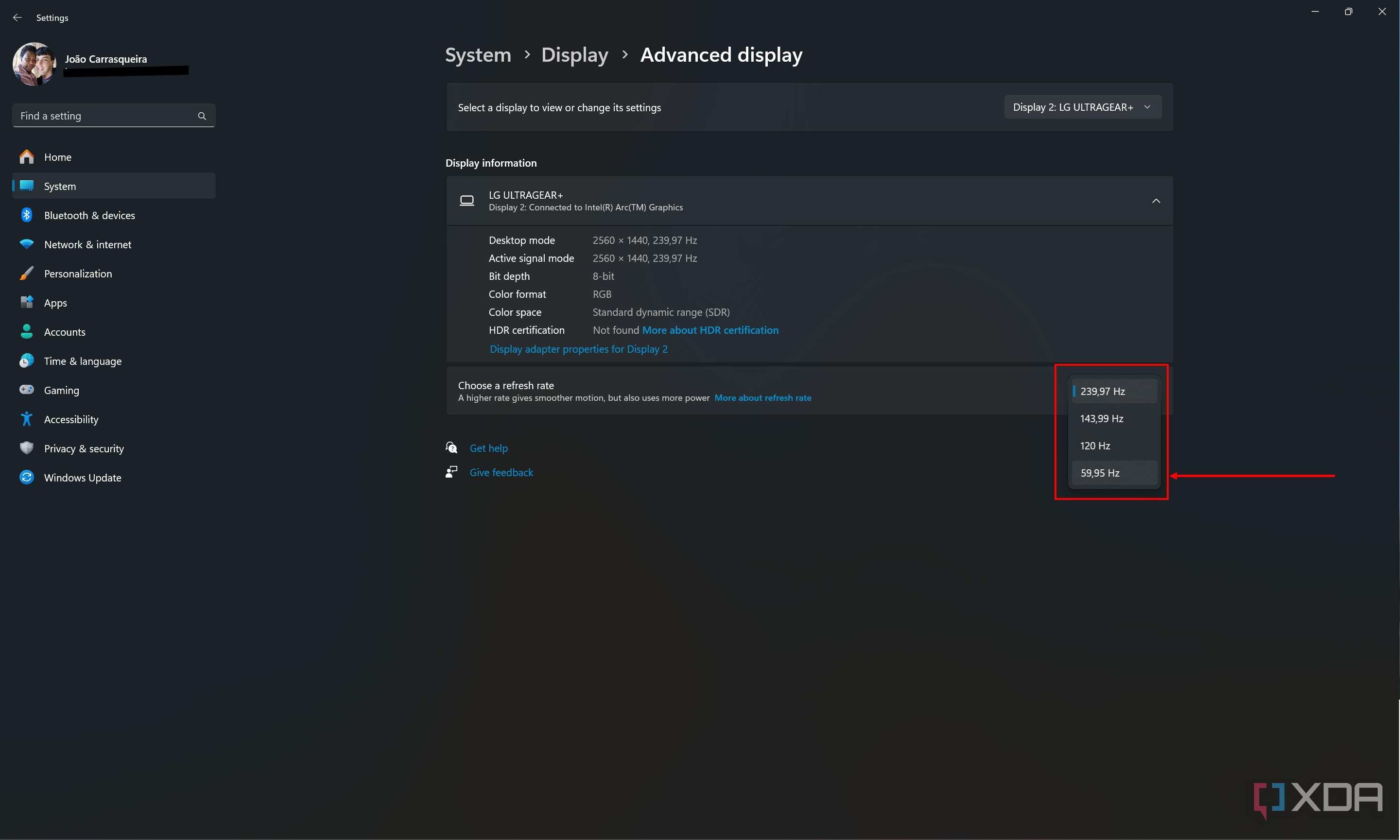 Screenshot of advanced display settings in Windows 11 showing a dropdown menu to change the refresh rate 