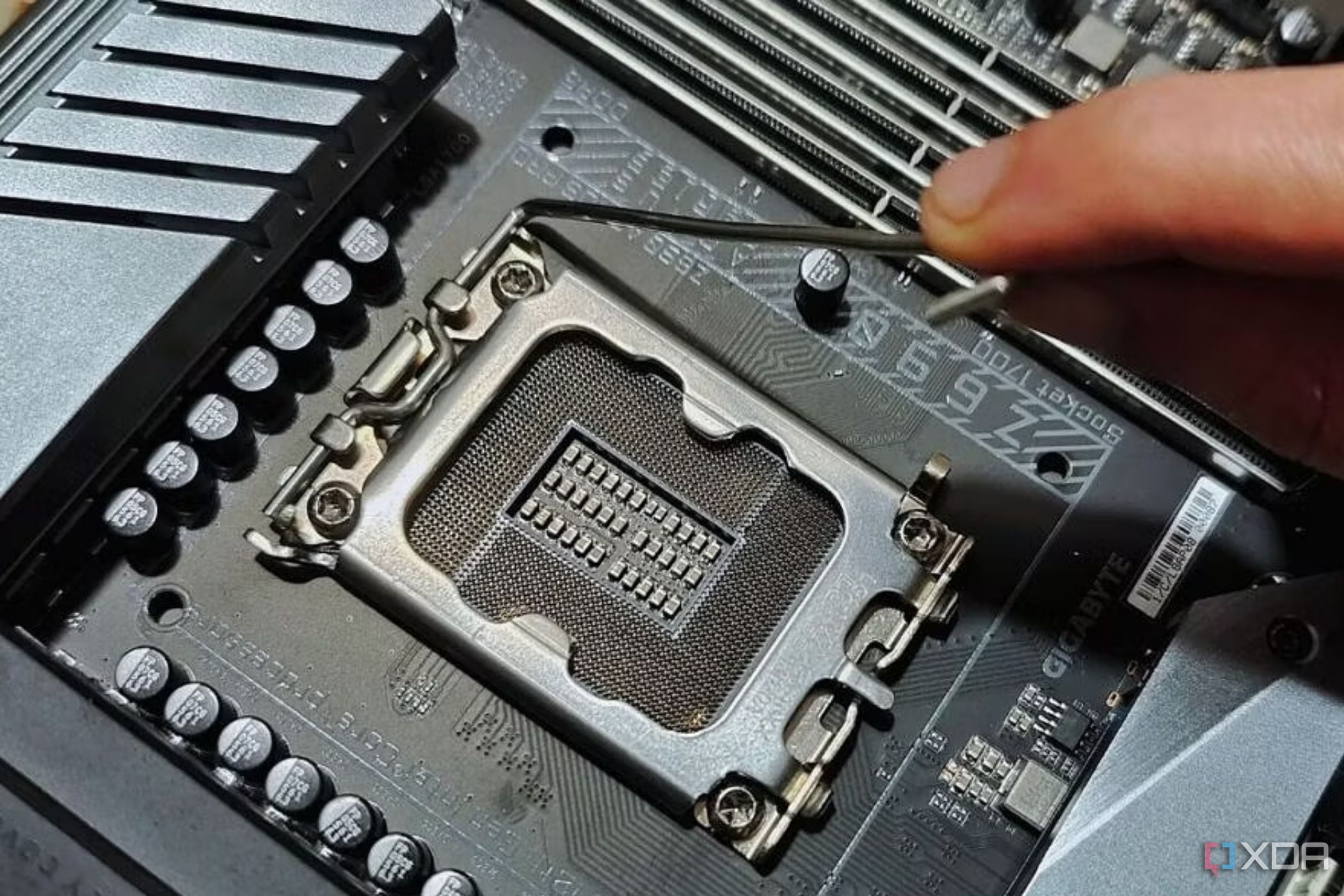 Изображение, на котором изображен человек, держащий металлический уровень, расположенный рядом с разъемом процессора.