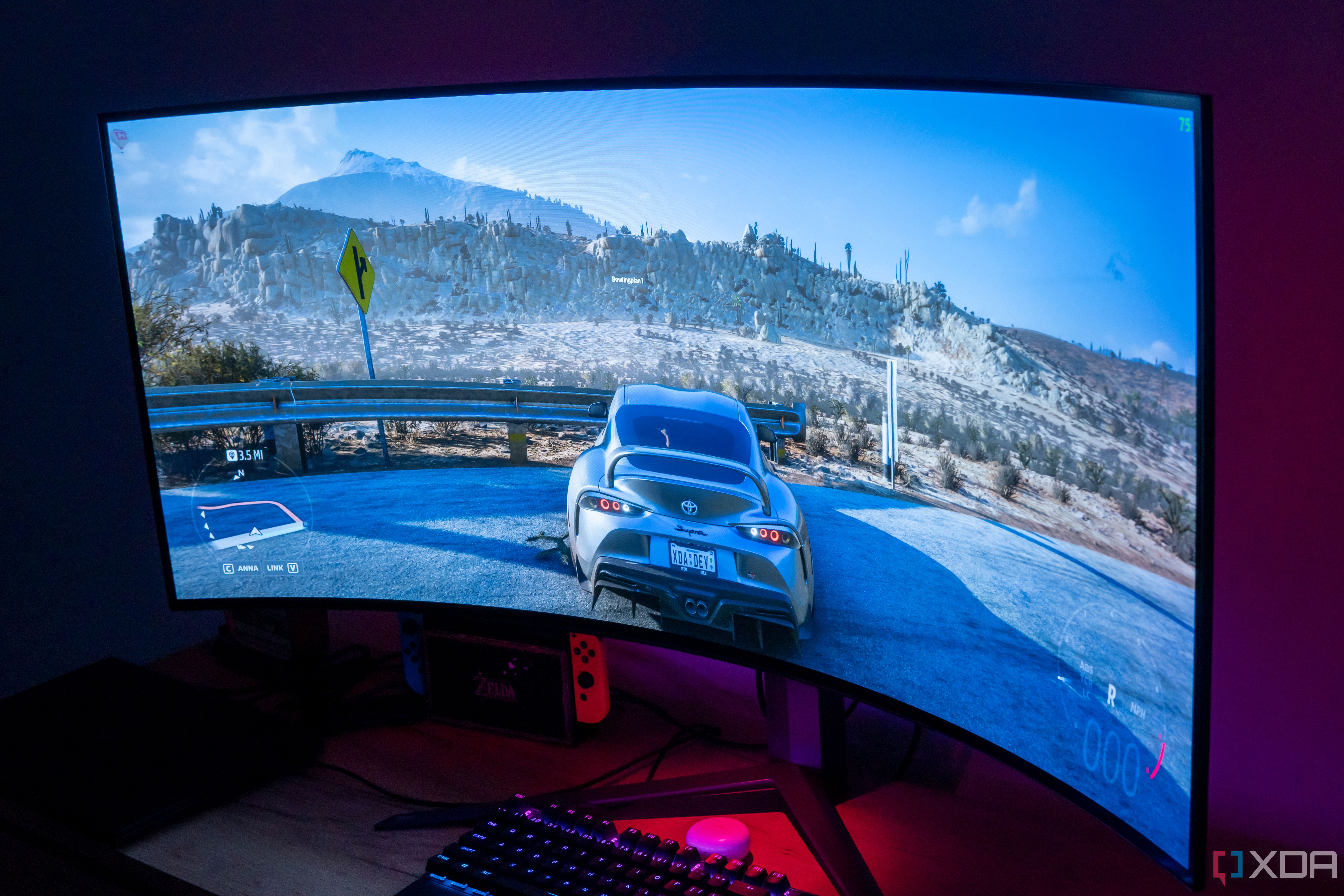 Angled view of the LG UltraGear 45GR95QE in a dark room with Forza Horizon 5 on the screen