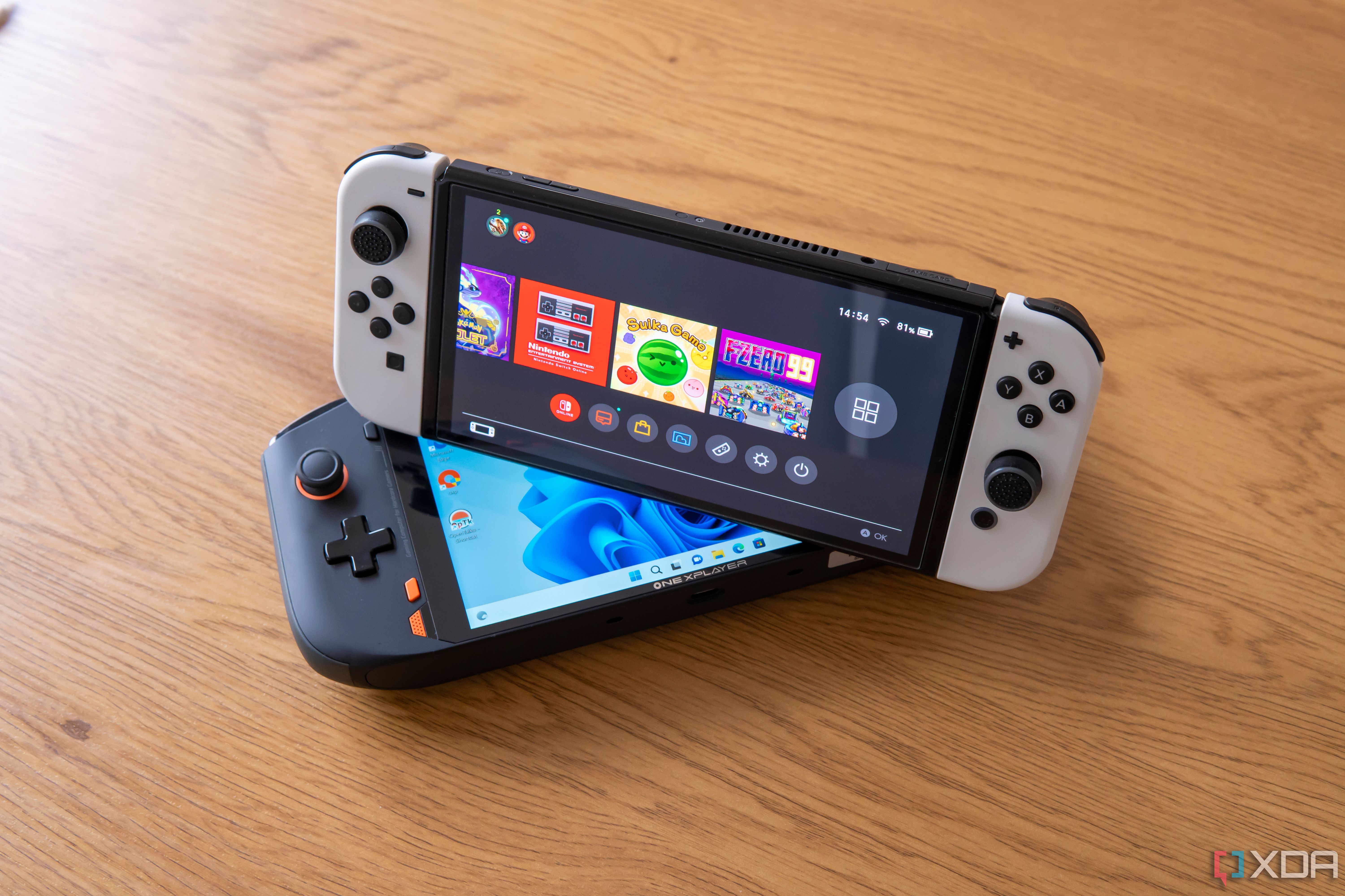 A Nintendo Switch OLED model on top of a One Xplayer Mini pro gaming handheld