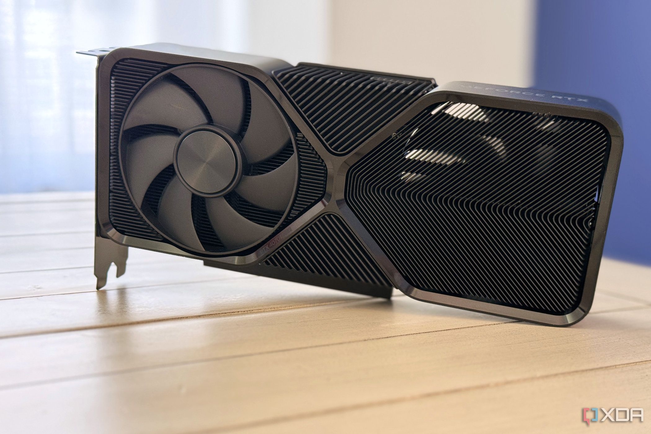 nvidia geforce rtx 4070 super founders edition stood up on table with light coming through the heatsink
