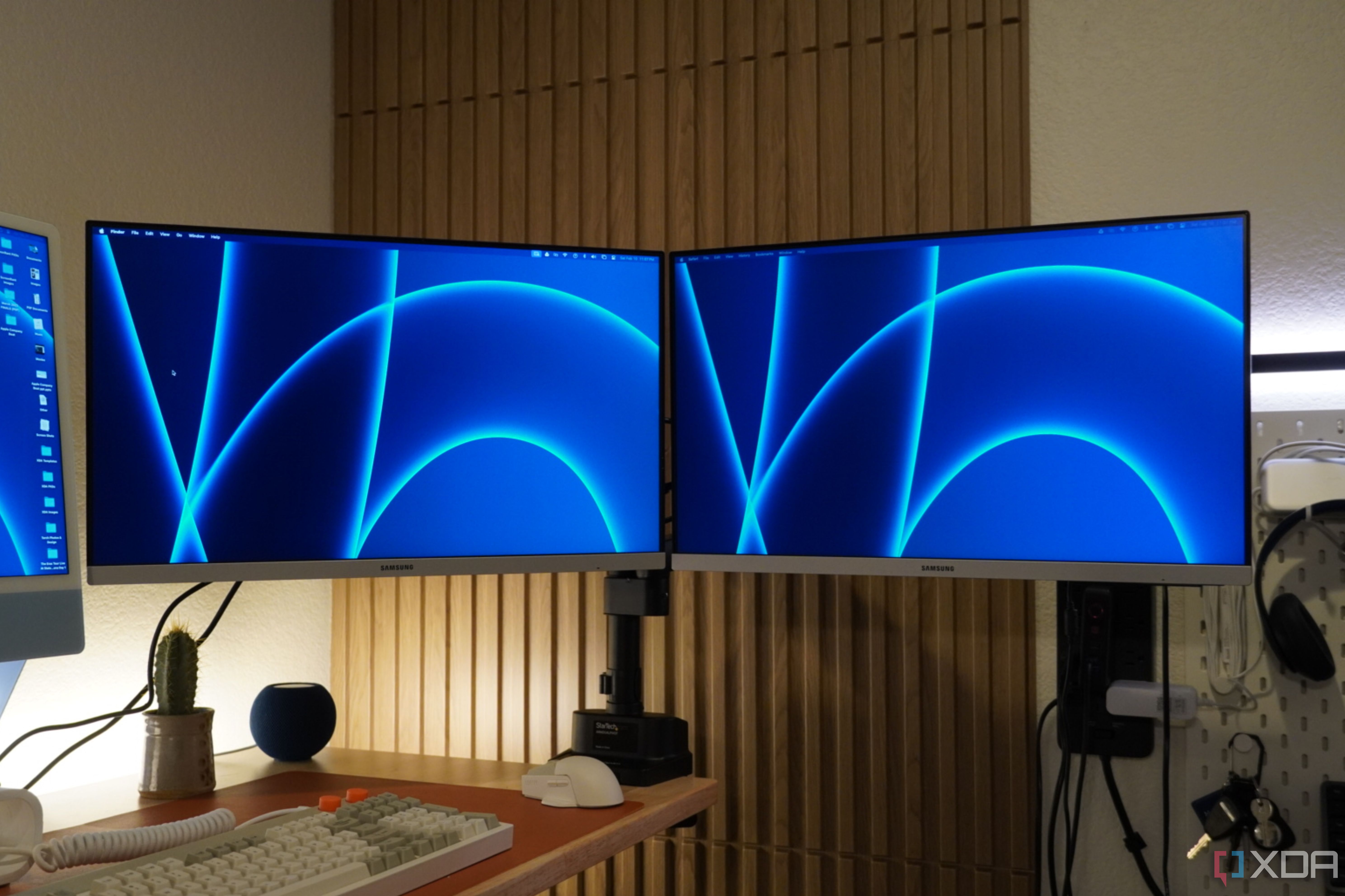 Two Samsung monitors connected to the StarTech dual monitor arm.