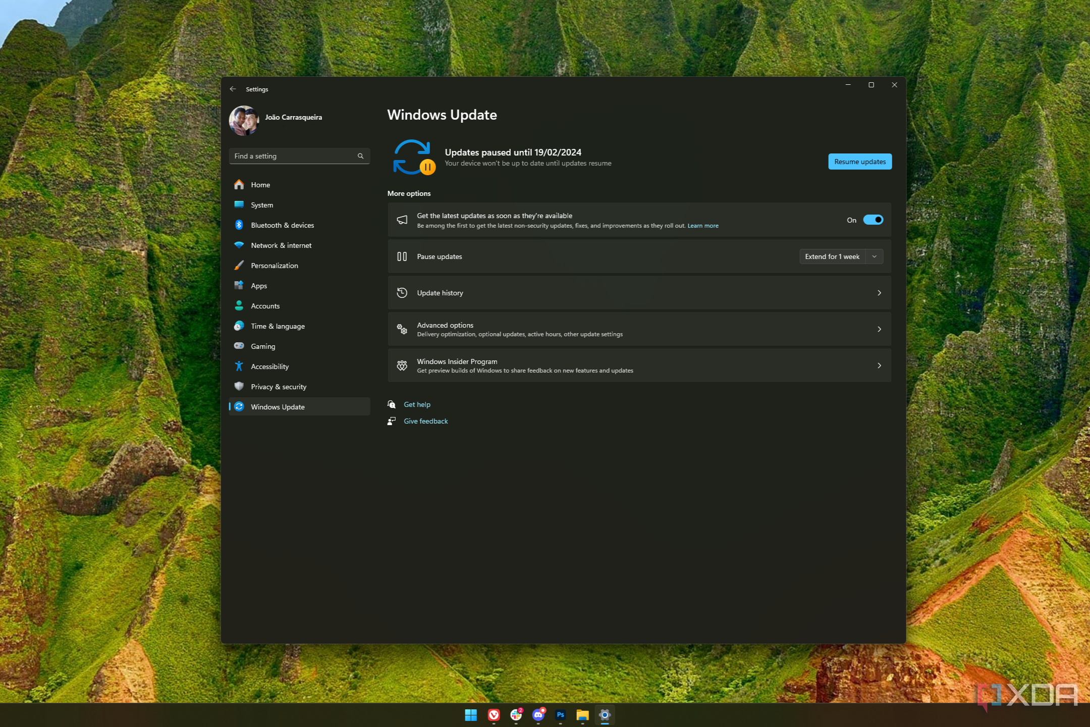 Screenshot of a Windows 11 desktop with the Windows Update page showing updates are paused
