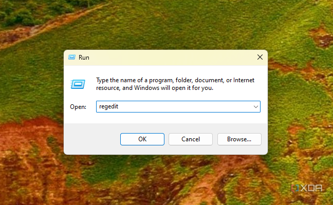 Screenshot of the Run dialog in Windows 11 with the regedit command entered into the box