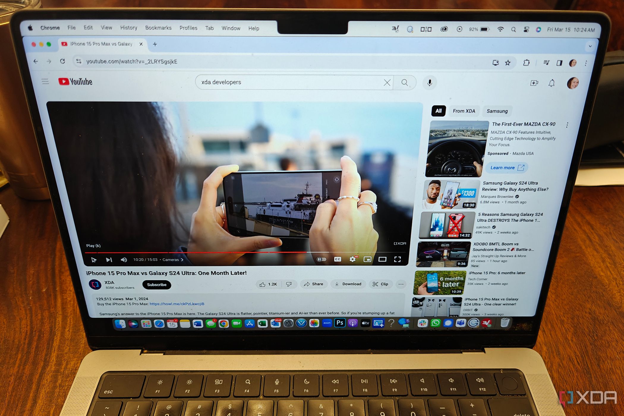 A MacBook Pro with a YouTube video playing on screen.