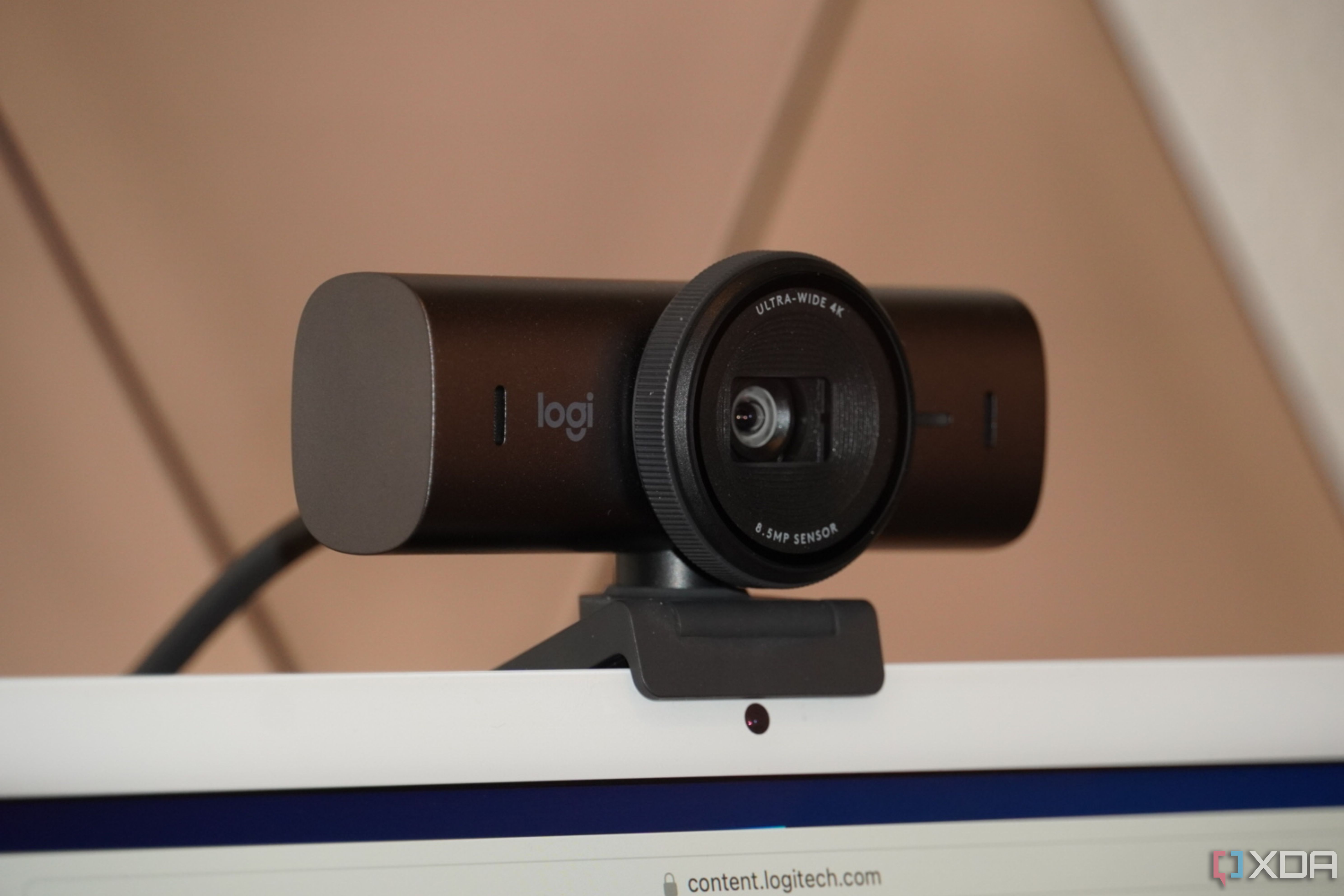 The Logitech MX Brio webcam mounted atop an iMac.