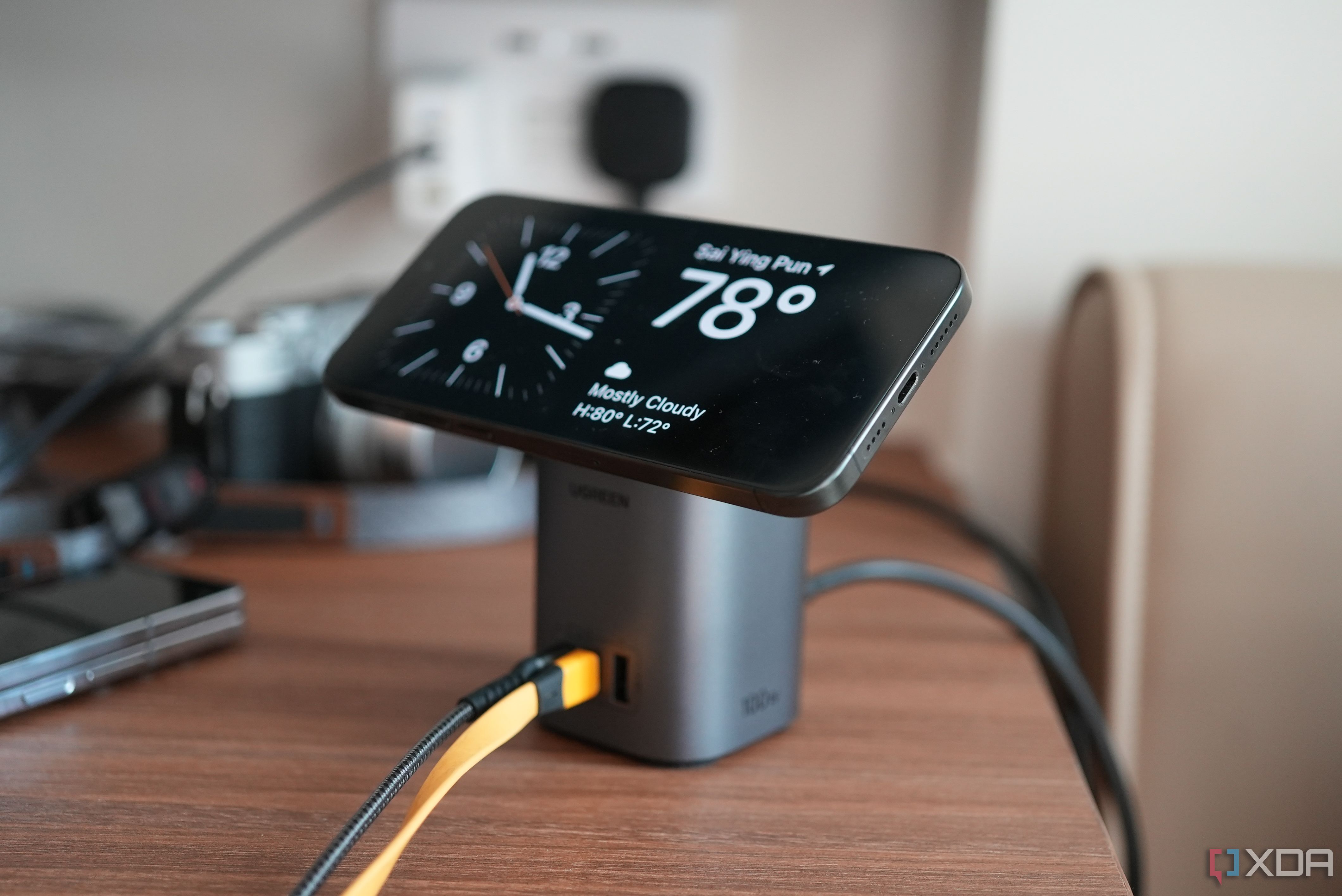Ugreen 100W MagSafe Charging Station with an iPhone on top 