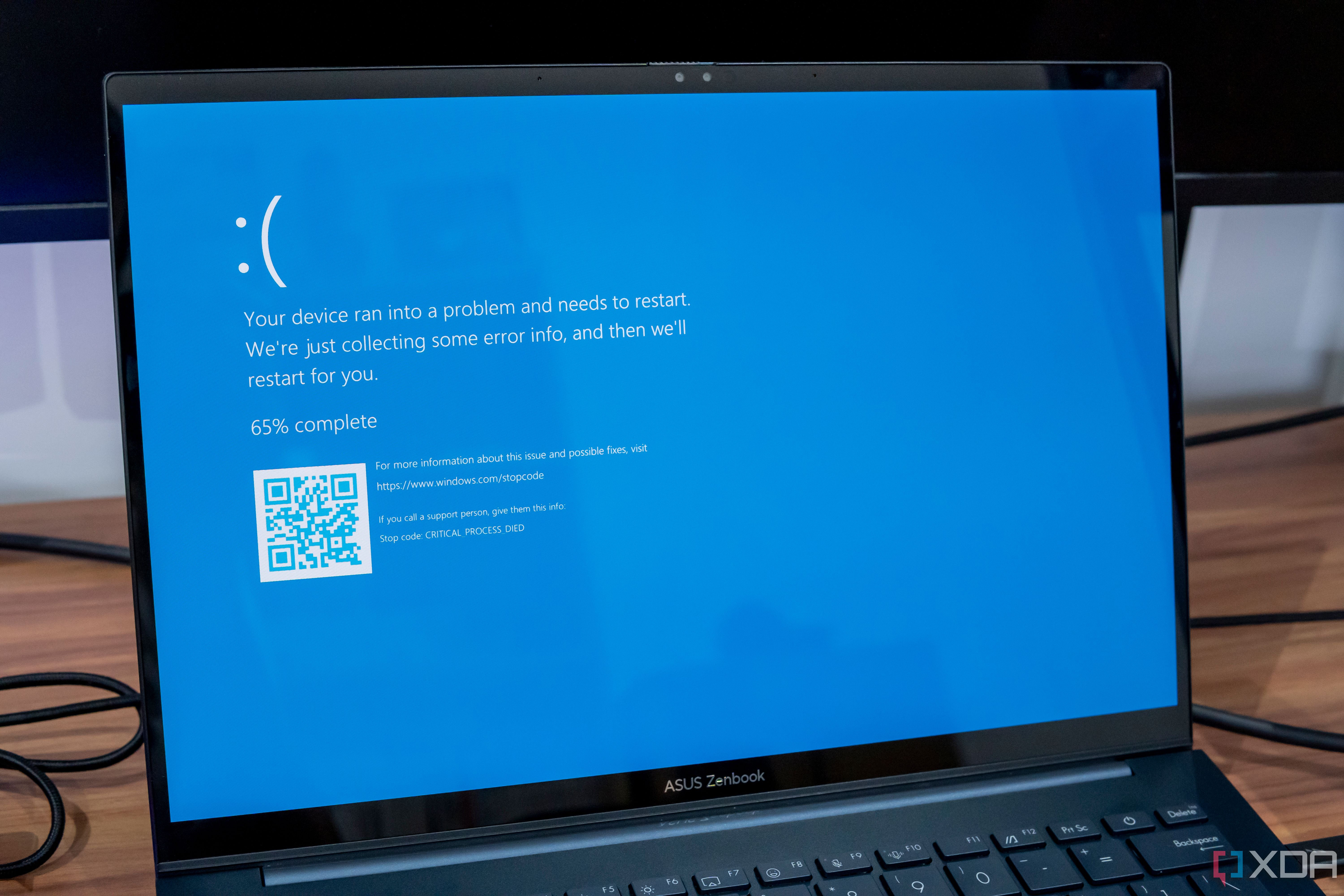 A Windows 11 laptop showing a Blue Screen of Death