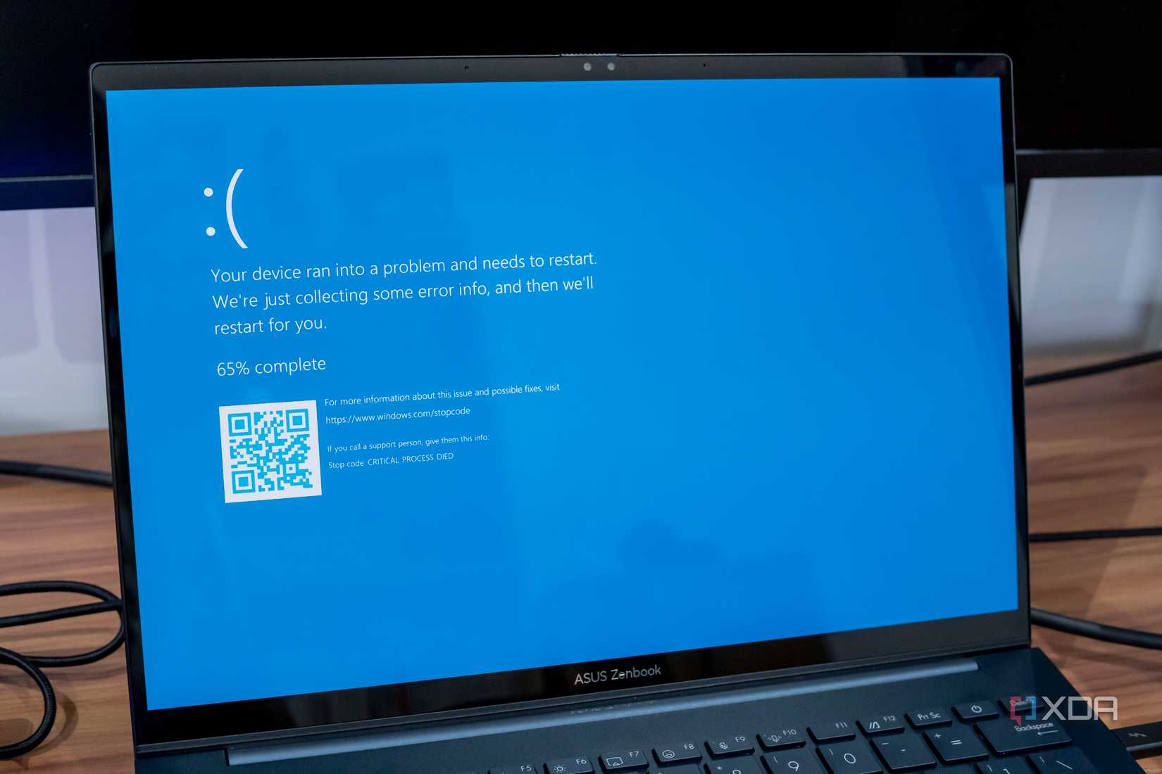 A Windows 11 laptop showing a Blue Screen of Death