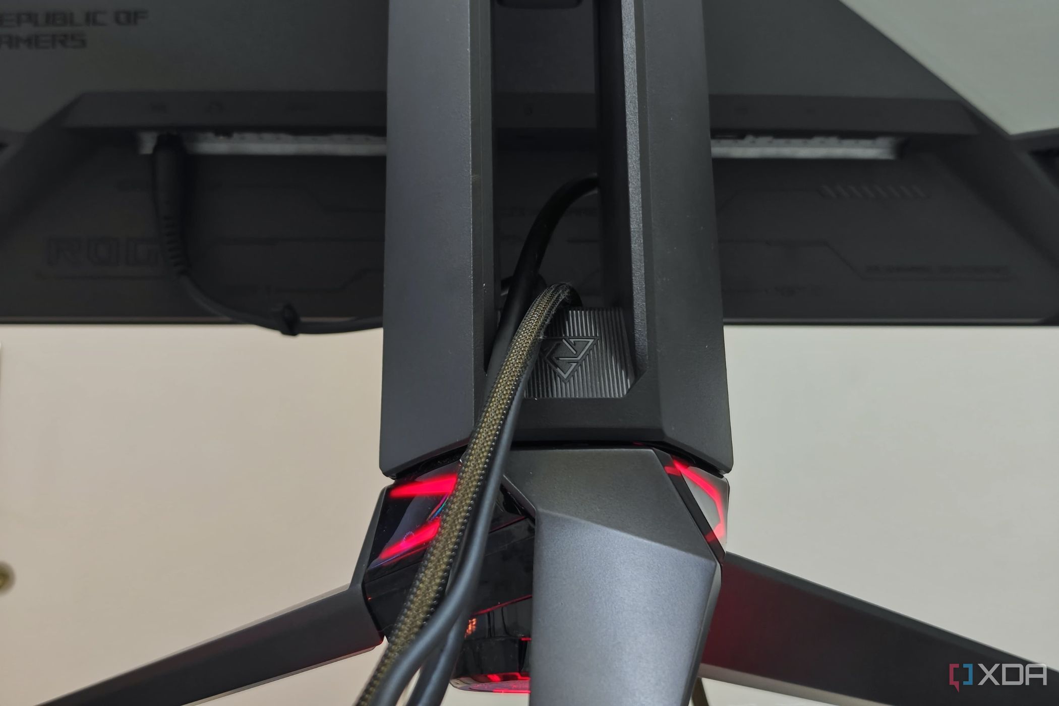 Una imagen que muestra el soporte del trípode del Asus ROG PG27AQDM con cables pasante a través de él.