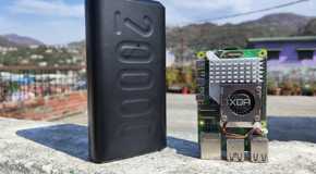 A Raspberry Pi 5 with a power bank placed near it